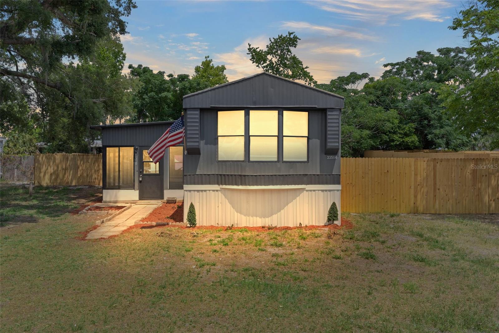 RENT TO OWN! Welcome to Leesburg, Florida! This remodeled 3-bedroom, 2-bath manufactured home offers an affordable path to homeownership with NO HOA and NO LOT RENT — you own both the home and the land. Inside, you’ll find a spacious open floor plan with a living room/dining room combination, new vinyl flooring, fresh interior paint, new window treatments, and new stainless steel appliances. The laundry closet includes a NEW washer and dryer, and major updates include 2 NEW mini-split AC units and a NEW water heater. The home sits on well water and septic and features a fenced backyard with extra outdoor space—perfect for a garden, playground, chicken coop, or your own creative use. The metal roof and surrounding dirt road give the property a charming country feel while still being just about 6 minutes from Lake Square Mall, movie theaters, grocery stores, shopping, and restaurants. Zoned for Treadway Elementary, Tavares Middle, and Tavares High School. Affordable, updated, and move-in ready—call today!