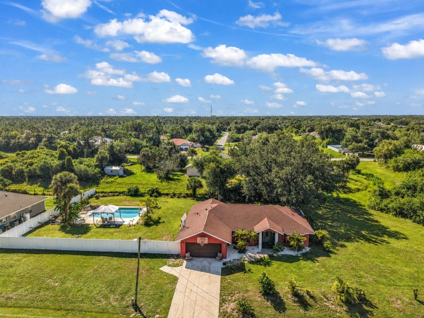 ROOM TO LIVE, PLAY, AND SPREAD OUT ON AN OVERSIZED 0.69-ACRE LOT! Tucked away in a desirable North Port neighborhood, this 3-bedroom, 2-bath home offers the space and privacy that's becoming harder to find. Situated on an expansive 0.69-acre lot, there's plenty of room for boats, RVs, trailers, outdoor toys, gardening, or creating the backyard oasis you've always envisioned—without the restrictions of an HOA. Inside, the home features a bright, open layout with soaring cathedral and vaulted ceilings that create an airy feel throughout the main living areas. Tile flooring runs through much of the home, while the spacious kitchen offers wood cabinetry, ample storage, and overlooks the living and dining spaces, making it ideal for everyday living and entertaining. Step outside to your own private backyard retreat featuring a HEATED SALTWATER POOL. Whether you're enjoying a swim year-round, entertaining family and friends, or simply relaxing poolside, this outdoor living space is designed to be enjoyed in every season. The oversized yard beyond the pool offers endless opportunities to add a detached garage, workshop, garden, play area, or simply enjoy the extra privacy that comes with owning nearly three-quarters of an acre. Additional features include a two-car attached garage, well and septic utilities, and a convenient location close to shopping, dining, parks, schools, golf courses, and everything North Port has to offer, while still providing the peace and privacy of oversized-lot living. If you've been searching for a property with room to grow, room for your hobbies, and the opportunity to make it your own, this North Port home is one you won't want to miss. Schedule your private showing today!
