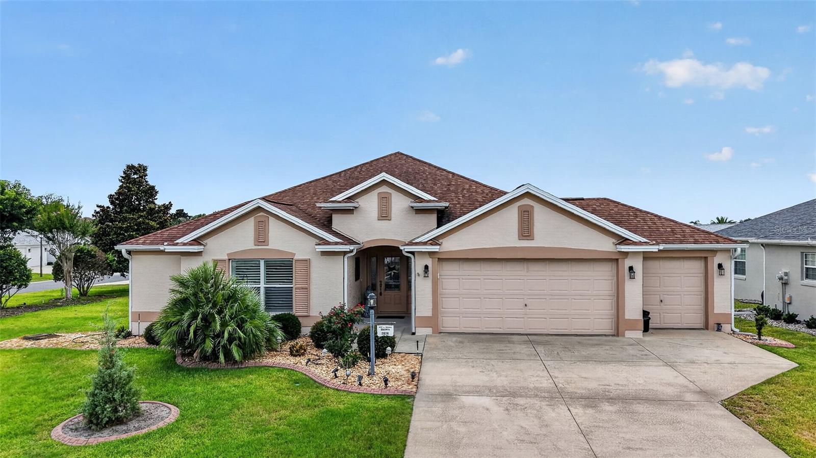 In The Villages, you have choices and decisions to make—why settle when you can have it all? This beautifully appointed 3-bedroom, 2-bath Holly Model is situated on a desirable corner lot in the Village of Pennecamp with the BOND PAID! Designed for both comfort and style, this home features a golf cart garage, tile and engineered wood flooring, cherry-stained cabinetry, crown molding throughout, granite countertops, stainless steel appliances, a spacious kitchen island, and a built-in desk area. The owner's suite offers his-and-her walk-in closets, dual vanities, and a Roman shower. Plantation shutters throughout the home add elegance and privacy. Relax year-round in the enclosed Florida Room just off the living area, perfect for entertaining or enjoying your morning coffee. Conveniently located just a short golf cart ride to both Lake Sumter Landing and Brownwood Paddock Square, you'll enjoy easy access to shopping, dining, entertainment, recreation centers, and an abundance of championship and executive golf courses. The Villages lifestyle is right at your doorstep. This is a home that truly must be seen to be appreciated!