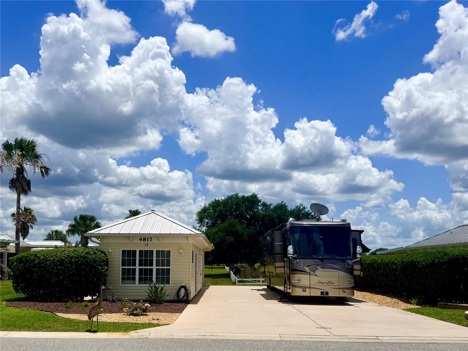 Welcome to luxury motorcoach living at Florida Grande Motor Coach Resort — known as “Florida’s Friendliest Motorcoach Resort.” This beautifully maintained north-facing back-in property offers 5,076 square feet with a reinforced 26’x76’ concrete motorcoach pad, providing plenty of room for even the largest Class A motorhomes. Full motorhome hookups are already in place, making this property ready for immediate enjoyment.

Located adjacent to peaceful pasture views, this lot offers a quiet and relaxing setting while still being close to all of the resort’s amenities. The 384 sq ft Grande Suite features thoughtful upgrades throughout including built-in bookshelves, elegant ceiling details, tile flooring, and a spacious kitchenette complete with a full-size refrigerator. The full bathroom includes heavy glass shower doors for a high-end finish. A separate laundry/storage room provides additional functionality and includes a water softener plumbed both to the suite and directly to the motorhome pedestal for softened water service.

Outdoor living is just as inviting with a covered 12’x16’ patio and ceiling fan — the perfect place to relax with morning coffee or entertain friends and neighbors.

Florida Grande is a gated Class A and Super C motorcoach resort situated on 275 acres in peaceful Central Florida. Owners enjoy oversized deeded lots, a 20,000 sq ft clubhouse, resort-style pool and spa, fitness center, library, billiards room, craft room, dog park, pickleball courts, and miles of scenic nature trails. The resort is known for its welcoming atmosphere, active social calendar, and strong sense of community where neighbors quickly become friends.

Conveniently located approximately one hour from Orlando, Tampa, and Ocala, and just 30 minutes from The Villages, Florida Grande makes an ideal home base for enjoying everything Central Florida has to offer while still returning home to peace, privacy, and luxury RV resort living.