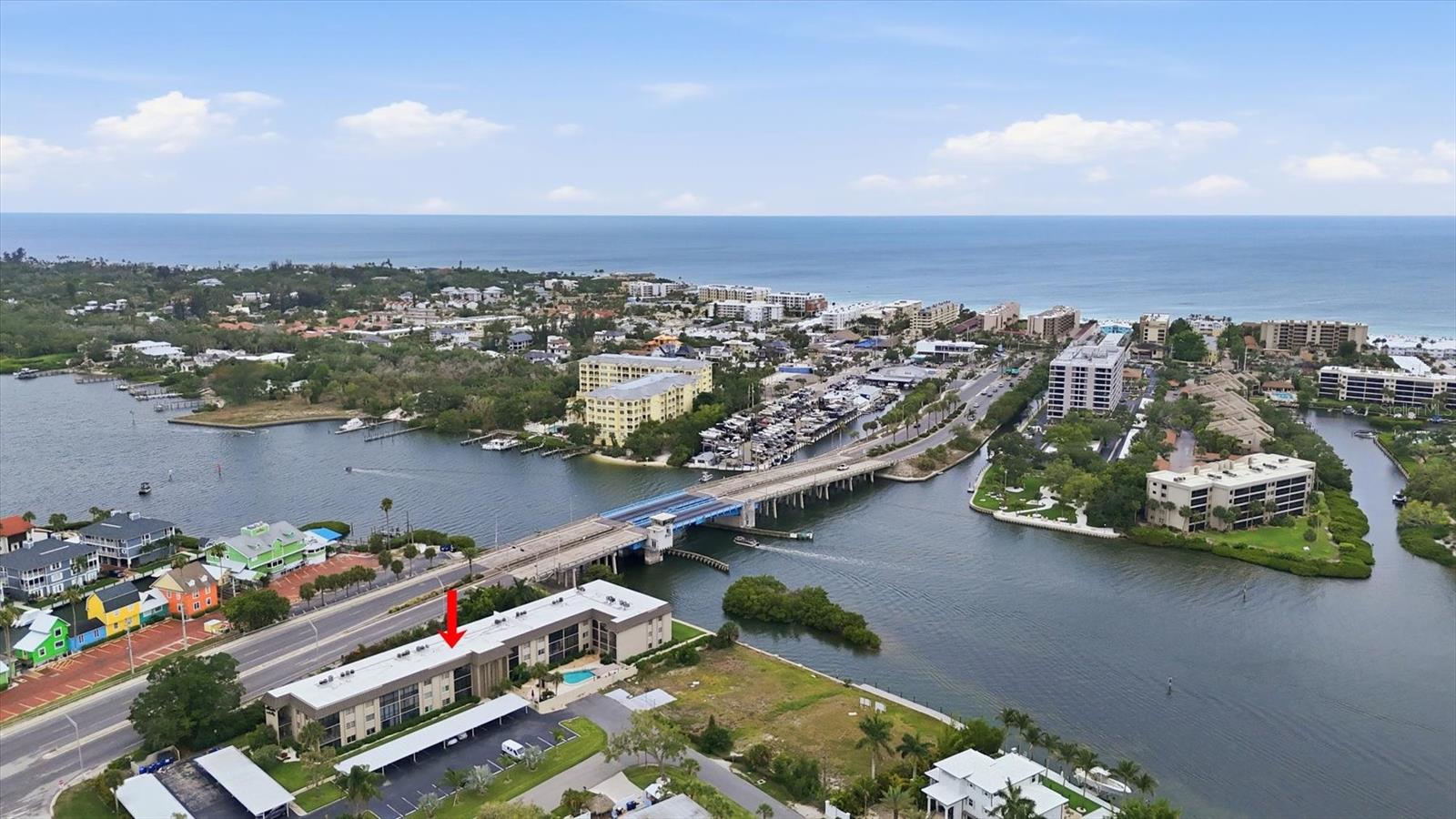 Updated waterfront condo just a short stroll to Crescent Beach and the fun and funky South Siesta Key Village!  A Five-minute drive or trolley ride to the main Siesta Village. Lounge by the heated pool or pull your boat up to this nicely remodeled 2 bedroom/2 bath Almeria by the Bay unit. Located on the 2nd floor (with an elevator) , this unit boasts a coastal kitchen with a convenient breakfast bar, new luxury vinyl floors (2026), and amazing Intercoastal water views from the primary bedroom and screened lanai. Both bathrooms have been thoughtfully updated, and this unit is being offered turn-key furnished.  It features a Beachy décor throughout. Fish or Kayak right from your own complex !  Monthly rentals are allowed and sought after. There's also a large, private storage area. Whether it is a forever home, vacation get-away or investment property, this is one of the most affordable move-in ready units located so close to the beach.