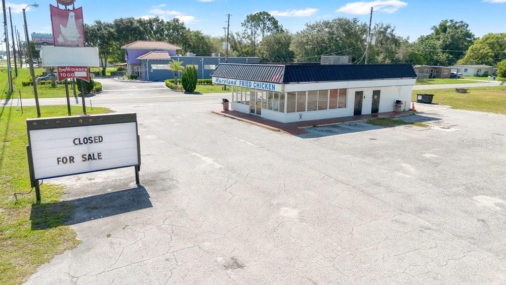 Rare opportunity to acquire a freestanding restaurant property at a signalized corner with outstanding visibility, ample parking, over half an acre of land, drive thru, and direct frontage on a heavily traveled roadway. Formerly operated as the well-known Maryland Fried Chicken, this fully equipped restaurant offers an ideal setup for an owner-operator or a new restaurant concept.

The building features a spacious dining area, customer service counter, commercial-grade kitchen with multiple fryers, stainless steel prep stations, vent hood system, walk-in refrigeration, and much of the equipment needed to reopen quickly. The recognizable pylon signage and generous parking lot provide excellent exposure and convenient customer access.

Positioned on a large site with room for future improvements or outdoor seating, the property benefits from strong traffic counts and excellent accessibility. The surrounding area includes established residential neighborhoods, local businesses, and major commuter routes, creating a steady customer base.  Close to the University of Central Florida and Valencia College!  Family owned and operated since 1970 but owners passing is why the restaurant has closed. Community and neighbors would love to have the restaurant back open.

Whether you're looking to revive a beloved local institution, launch a new restaurant brand, or acquire a highly visible commercial investment, this property offers tremendous potential.

Highlights:
Freestanding restaurant building
Signalized hard corner location
High traffic visibility
Large parking lot
Commercial kitchen with existing equipment
Prominent pylon signage
Dining room ready for customization
Excellent opportunity for owner-users, investors, or franchise operators

Don't miss this chance to own a highly recognizable restaurant property with endless possibilities on the East side of Orlando.