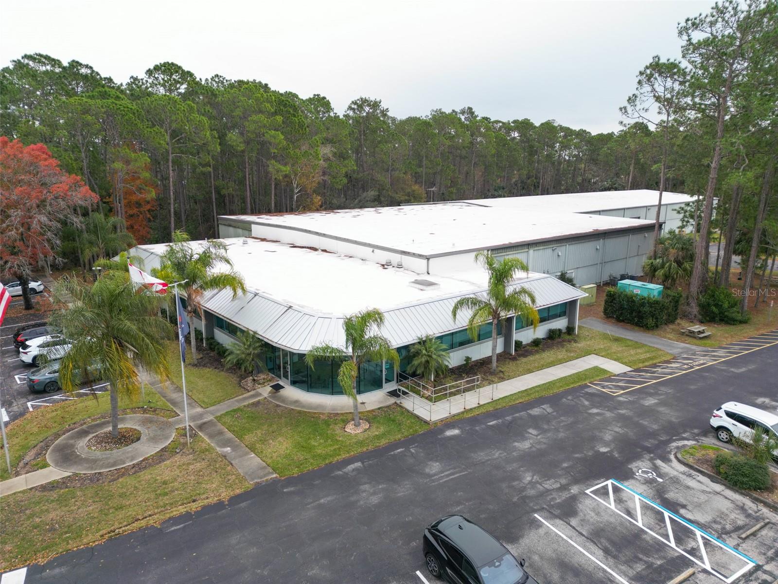 Palm Coast Flagler County, Industrial building 35000+/- warehouse space and 6000+/- finished modern glass office space. Ready for new owner. Located in the heart of Palm Coast and Flagler County with easy access to US1 and I95 corridors. Property features 4 loading docks 18 foot doors 1 16 foot drive in door, Ceiling height 20 foot, building generator, 3 walk-in refrigerators, A/C throughout all spaces. Modern appointed conference / meeting spaces. Employee kitchen areas and executive bathrooms. EV charging stations and ample employee parking. This turn-key property is ready for its new owner and ideal for industrial, logistics, or corporate use..