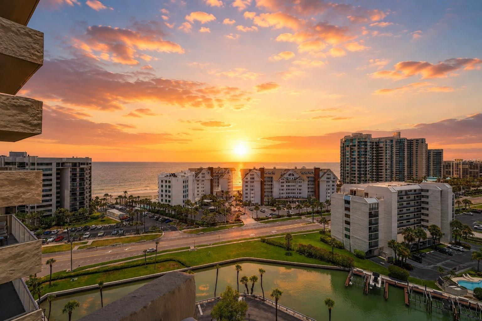WATER VIEW FROM EVERY ROOM!!! OUTSTANDING VALUE FOR THIS SPACIOUS CONDO WITH WRAP AROUND CORNER BALCONY. This 2 bedroom, 2 bath, 1,500sqft condo with 1 car carport brings to you the best of boating and the beach. This cozy NE corner residence in the quiet GATED waterfront community of Isle of Sand Key is tucked away from Gulf Blvd, but is only a short 3-minute walk to the powder soft sands of Sand Key Beach. The first come, first serve boat slips allow for fast, easy access to the Intracoastal waterway and the Gulf. The kitchen with breakfast bar is ready for your culinary creations, featuring a GORGEOUS INTRACOASTAL WATER VIEW. Newer washer/dryer installed. There’s plenty of space for an 8-10 dining set for large families. The sizable 300sf master suite enjoys both Gulf and Intracoastal views and you can even hear the sound of the ocean! The walk-in closet is enormous! Step out onto the balcony and your cares instantly melt away. You have panoramic water views in every direction. The Isle of Sand Key gated community offers relaxing resort amenities such as a solar-heated community pool, BBQ area, covered sitting area, docks for fishing, boat slips (first come), sauna and fitness center! Only minutes away from award-winning Clearwater Beach. With its uncommon size & sleeping capabilities, this residence is ideal for entertaining with extended stays for families & guests. A great location & terrific value! UPGRADES: NEW AC 2019, NEW Water heater 2025, NEW Impact Windows 2018. **BE SURE TO CHECK OUT THE 3D VIRTUAL TOUR LINK.**