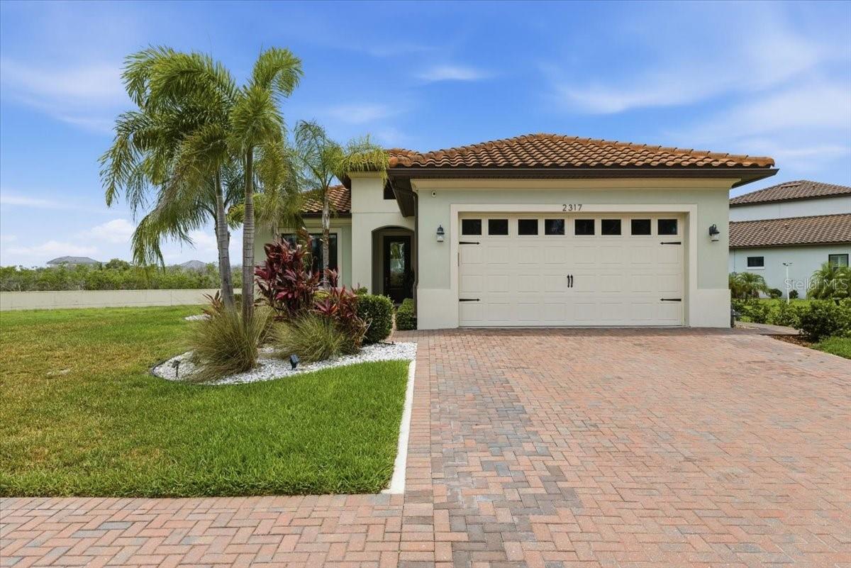 Located in the gated boating community of Sanctuary Cove Riverfront Estates, this San Remo floor plan offers 3 bedrooms, 2.5 baths, a flex room, and an open layout designed for comfortable everyday living and entertaining. The center-island kitchen overlooks the spacious family room, where a full wall of hurricane-rated sliding glass doors opens to the covered, screened lanai, creating seamless indoor-outdoor living.

The primary suite is privately located at the rear of the home and features a spa-like walk-in shower, double vanity, and oversized custom walk-in closet. Two secondary bedrooms share a full bath and are situated away from the main living area for added privacy. Additional features include quartz countertops, a gas range, tall ceilings, custom closets throughout, on-demand hot water, whole-home water filtration system, brick paver driveway, and an outdoor kitchen.

Situated on an oversized lot next to a protected conservation area, the home offers added privacy along with canal views and beautiful western sunsets. Enjoy watching the Fourth of July fireworks over the Manatee River right from your lanai.

Sanctuary Cove is a waterfront community with a 210-slip marina offering quick and easy access to the Manatee River. Boat ownership is not required, and slips are available for lease. Residents enjoy a wide range of amenities, including an 8,600-square-foot clubhouse with internet café, fitness center, resort-style pool, game room, riverfront park, nature preserve, kayak launch, and beach area for kayaking and paddleboarding. Lawn maintenance is included, making it easy to enjoy the Florida lifestyle without the upkeep.

Whether you enjoy boating, fishing, kayaking, staying active, or simply relaxing by the water, Sanctuary Cove offers a lifestyle that is hard to match.