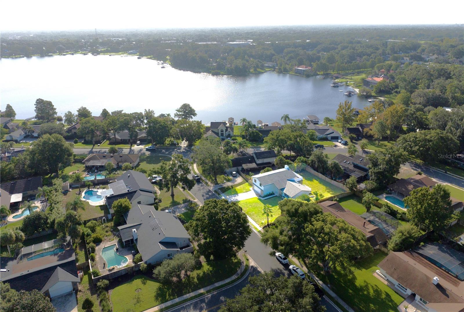 One or more photo(s) has been virtually staged. Bring your boats, jet skis, fishing gear, and ALL the things!! Over 2,500 square feet of renovated elegance in the highly desired Jennifer Estates neighborhood await your arrival. Walk into this true Mid Century Modern home and take in the high quality/luxurious finishes, from the modern ceiling fixtures to the upgraded granite counters, you will feel as if you're walking into a model home. 
As you enter, a rustic-modern Mohawk Chestnut laminate flooring extends your warm welcome from the foyer into the open living/dining room and throughout the home. Completely re-imagined, the kitchen will take your breath away with new kitchen cabinets, new stainless steel Samsung appliances, and a large granite breakfast bar that opens into the living room. Oh! Lest we forget my favorite feature, a COFFEE/WINE BAR flanked by two large pantries that would put any Starbucks to SHAME! 
The lower level's secret is its multi-purpose room anchored by a wood burning fireplace engulfed with floor to ceiling natural, whitewashed painted stone. Easily a mom-in-law suite, game room, office, or theater equipped with a full bath!  A spacious laundry room complete with cabinetry and five feet of countertop space for easy laundry folding. That's right! NO more folding on the dining room table! An oversized 2-car garage updated with a new Smart opener and with plenty of room for a workbench, those jet skis, and even some paddle boards.
The upper level is your sweet escape from the party. Lay the baby down in their room and grab that monitor while the festivities continue downstairs. Retire at the end of the night in your spacious primary suite with its very own walk-out upper deck. 
The roof, A/C, and hot water heater were all replaced in 2021. This home is merely steps down the street to your HOA deeded, private access to Lake Brantley. A private beach, boat ramp, picnic pavilion, pickleball court, and basketball and tennis courts are all within this sought after community. A-rated schools, lush new landscaping, and the LAKE LIFE are calling your name! Schedule a showing today! Some photos have been virtually staged.