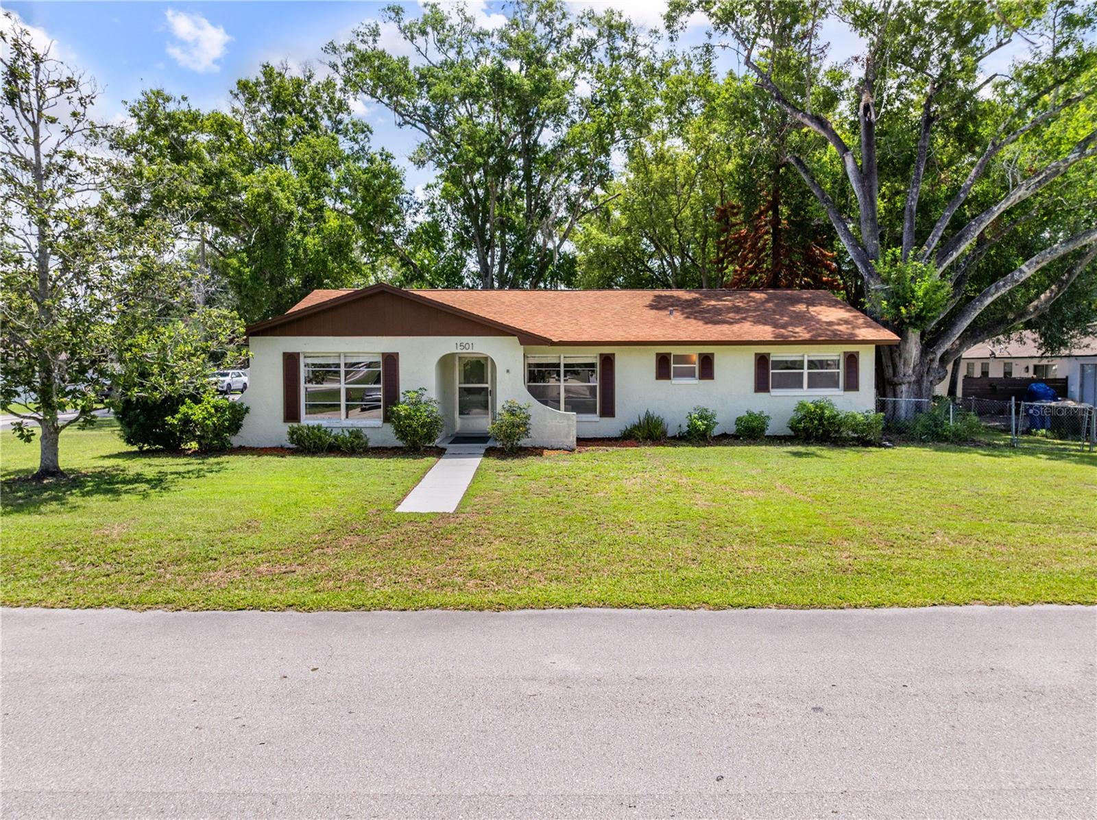 Welcome to this beautifully maintained 3-bedroom, 2-bath home that combines modern updates with timeless character. Situated on a spacious corner lot, this move-in-ready property offers flexible living spaces, major system improvements, and a convenient St. Cloud location.

Inside, you'll find brand new luxury vinyl plank flooring, fresh interior paint, updated lighting, and a bright, inviting floor plan designed for comfortable everyday living. The kitchen has been tastefully refreshed while maintaining its original charm and features a cozy eat-in dining area, perfect for casual meals and morning coffee. Both bathrooms have also been refreshed, preserving their classic character while providing a clean, updated feel.

A large bonus room adds exceptional versatility and can easily serve as a second living area, family room, game room, home office, fitness space, or playroom—tailored to fit your lifestyle.

Major improvements provide peace of mind, including a new roof (2021), new HVAC system (2021), Water Heater (2021) and new interior and exterior electrical panels, giving buyers confidence that many of the home's most important systems have already been updated.

The spacious primary suite includes a private bath, while two additional bedrooms offer comfortable accommodations for family or guests. Outside, the corner lot provides added curb appeal, extra yard space, and endless possibilities for outdoor entertaining, gardening, or simply relaxing.

Conveniently located near Historic Downtown St. Cloud, East Lake Tohopekaliga, shopping, dining, schools, medical facilities, Lake Nona Medical City, Orlando International Airport, and the Florida Turnpike, this home offers the perfect combination of comfort, convenience, and value.

Don't miss this opportunity to own a thoughtfully updated home with character, flexible living space, and major system upgrades already in place.