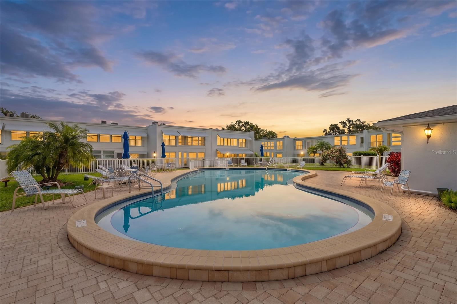 One or more photo(s) has been virtually staged. Welcome to easy Florida living in the highly sought-after 55+ community of Penthouse Groves! This spacious 2-bedroom, 2-bath second-floor end-unit condo offers the perfect blend of comfort, convenience, and an active lifestyle—with NO UPSTAIRS NEIGHBORS and BEAUTIFUL POOL VIEWS to enjoy from your private balcony overlook. Step inside to discover an open and inviting floor plan featuring an OVERSIZED GREAT ROOM with plenty of space for large furnishings and entertaining. Need extra flexibility? The adjoining BONUS SUNROOM is the perfect spot for a HOME OFFICE, reading retreat, hobby room, craft space, or additional sitting area. A WALK-IN STORAGE CLOSET provides valuable extra storage rarely found in condo living. The spacious EAT-IN KITCHEN is designed for both function and gathering, featuring a tile backsplash, DOUBLE-WIDE PANTRY, breakfast bar with room for barstools, and space to add a breakfast table, coffee bar, or credenza. Appliances include a refrigerator, dishwasher, electric range, and built-in microwave. The dining area is the perfect place to enjoy your morning coffee as it opens to a balcony overlook with relaxing pool views and sliding screen doors to enjoy the gentle Florida breeze. The generously sized primary suite is a true retreat, offering TWO CLOSETS—including a WALK-IN CLOSET with built-in shelving—and an ENSUITE BATH with a tub/shower combination, linen closet, and separate vanity area. The guest bedroom is also surprisingly large, while the guest bath features a step-in shower with pull-down sprayer and additional linen storage. Additional features of this condo include IMPACT-RESISTANT WINDOWS AND SLIDERS, INTERIOR LAUNDRY CLOSET with WASHER AND DRYER INCLUDED, ceiling fans, vertical blinds throughout, tile flooring in the entry and bathrooms, carpeting in the living areas and bedrooms, and a 2022 installed HVAC SYSTEM. Enjoy peace of mind in a NON-FLOOD ZONE and NON-EVACUATION ZONE location. The ASSIGNED COVERED CARPORT PARKING SPACE is conveniently located near the building, and COVERED GUEST PARKING is available as well. Beyond your front door, enjoy the resort-style amenities and vibrant social atmosphere that make Penthouse Groves such a desirable place to call home - including a HEATED POOL with SUNDECK and GRILLING AREA, CLUBHOUSE WITH FULL KITCHEN, FITNESS CENTER, SAUNA, LIBRARY, GAME ROOM WITH POOL TABLE, shuffleboard courts, and a SCENIC POND WITH FISHING PIER. Even better, the HOA FEE COVERS: WATER, SEWER, TRASH, CABLE TV, INTERNET, EXTERIOR MAINTENANCE, GROUNDSKEEPING, EXTERIOR PEST CONTROL, BUILDING INSURANCE, and RECREATIONAL FACILITIES. Conveniently located just 3 MINUTES FROM EAGLE LAKE PARK, 6 MINUTES FROM LARGO CENTRAL PARK, 3 MINUTES FROM PUBLIX, 8 MINUTES FROM BELLEAIR COUNTRY CLUB, and only 15 MINUTES FROM THE STUNNING WORLD-FAMOUS AND AWARD-WINNING CLEARWATER BEACH. Restaurants, shopping, healthcare, and everyday conveniences are all just minutes away. PROFESSIONALLY CLEANED and MOVE-IN READY, this is your opportunity to spend less time maintaining a home and more time enjoying friends, hobbies, community activities, nearby parks, beautiful Gulf beaches with breathtaking sunsets, and everything that makes Florida living so special. Come see why so many residents love calling Penthouse Groves home! Schedule your private showing today!