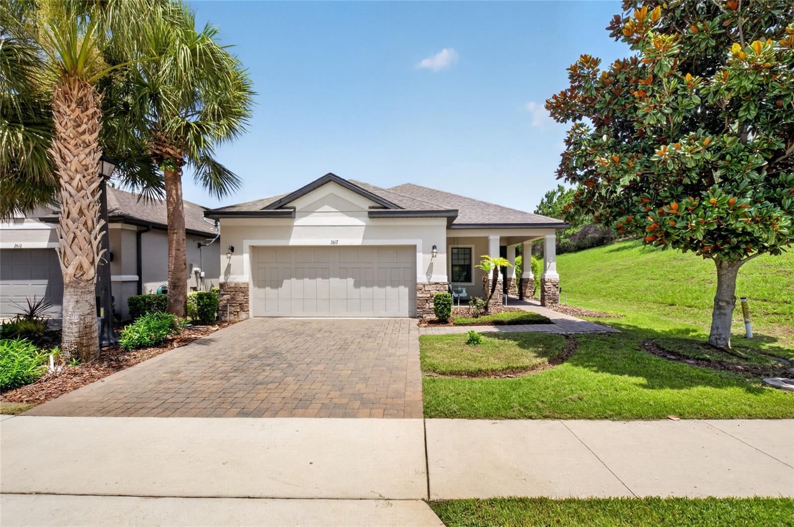 Welcome to 2612 Frazeek Court in the highly sought-after 55+ resort-style community of Esplanade at Highland Ranch! This beautifully maintained 3-bedroom, 2.5-bath home offers the perfect combination of comfort, privacy, and low-maintenance living. Filled with natural light, the open-concept floor plan creates an inviting space for everyday living and effortless entertaining. The spacious kitchen flows seamlessly into the living and dining areas, while the oversized covered lanai provides the perfect place to relax, enjoy your morning coffee, or host friends outdoors. With no neighbors on one side, you'll appreciate the added privacy and peaceful setting. Living at Esplanade at Highland Ranch means enjoying a true resort lifestyle. The HOA covers lawn and shrub care, irrigation maintenance, and the maintenance of the community's gates and roads. Residents enjoy an incredible lineup of amenities including a heated resort-style pool, spa, resistance pool, lighted tennis, pickleball and bocce ball courts, fire pit, outdoor kitchen, billiards, table tennis, card room, movement studio, dog park, and a full calendar of clubs and social activities. Conveniently located just 5 minutes from the new Crooked Can Brewing Co. in Minneola and only 15 minutes to historic Downtown Clermont, you'll have easy access to great dining, shopping, entertainment, and waterfront parks while coming home to one of Central Florida's premier active adult communities. Come experience the lifestyle you've been waiting for at 2612 Frazeek Court!