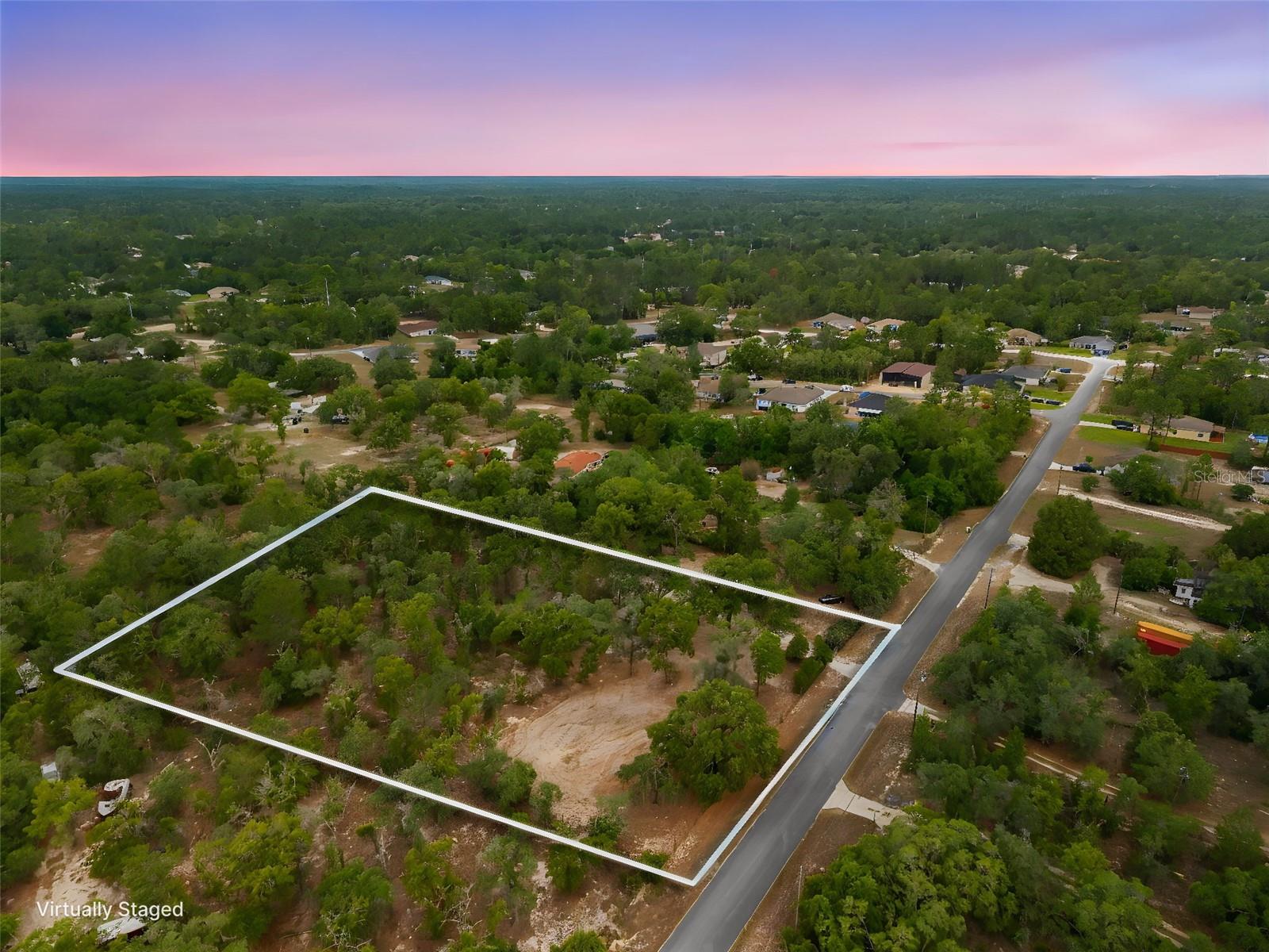 2.6 Acres. No HOA. No Flood Zone. No CDD. Just Opportunity. 

Ready to build your dream home in one of Hernando County's most sought-after areas? 

This 2.6-acre parcel in Weeki Wachee is your blank canvas -- PARTIALLY CLEARED, FULLY FENCED, GATED, and ready for you to break ground. NO HOA. NO CDD. NO FLOOD ZONE! Just land, privacy, and freedom to build the way you want. 

Zoned AR-2 -- AGRICULTURAL RESIDENTIAL -- meaning you can build your home AND bring your animals, your equipment, and your lifestyle. Horses, chickens, hobby farm -- this zoning supports it all on your 2.6 ACRES with no HOA telling you otherwise. 

A previous mobile home has been removed from the property -- a well and septic were in place to serve that home and remain on site. A portion of impact fees may have been previously paid -- buyer to verify with the county. ELECTRICITY ON SITE!! 

PAVED ROAD frontage means no dirt road drama getting to your future front door. Zoned for WINDING WATERS K-8 and WEEKI WACHEE HIGH SCHOOL -- the county's newest schools and already among the most in-demand in the area. 

At 2.6 FENCED ACRES you've got room to breathe, room to build, and room to grow. Bring your builder. Bring your plans. This one checks every box.