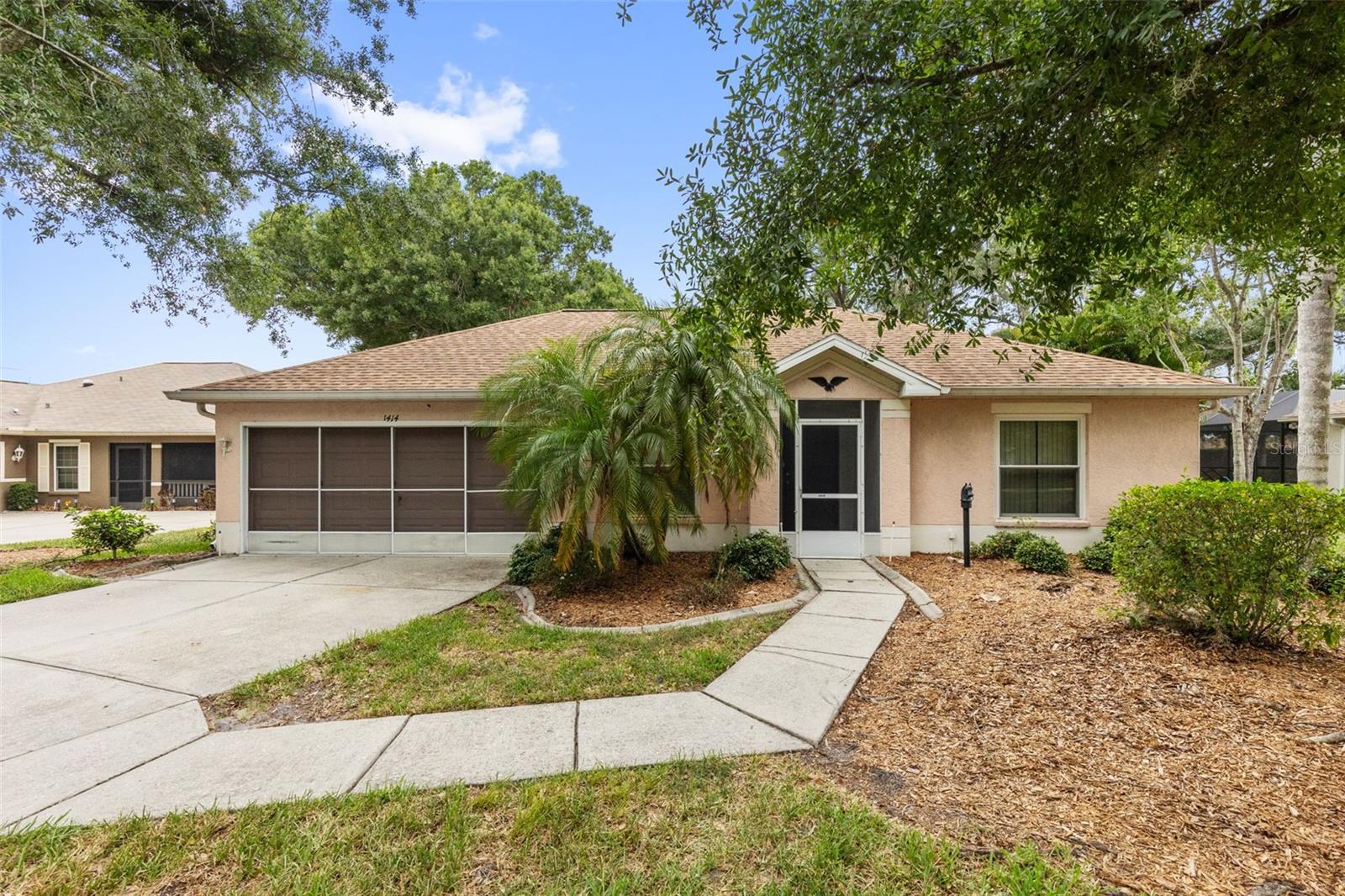 Truly move in ready home nestled on a peaceful, tree lined street in the highly desirable Bluewater Circle of Sun City Center. Situated on an oversized 0.29 acre lot, this property offers a rare combination of privacy, serenity, and exceptional value.
From the moment you arrive, you'll appreciate the long driveway, mature landscaping, screened front entry, and inviting curb appeal. The spacious backyard is a standout feature, providing a tranquil setting where you can relax, enjoy nature, and watch local wildlife from the comfort of your Florida room.

Inside, the thoughtfully designed split bedroom floor plan offers 2 bedrooms, 2 full bathrooms, comfortable living space. The open layout features newer luxury vinyl flooring throughout the main living areas, higher ceilings, abundant storage, and a bright kitchen with a breakfast nook. All appliances, including the washer and dryer, convey with the home. The guest bathroom features a convenient walk in tub, while the primary suite offers dual closets for added storage.

Major updates provide peace of mind, including a BRAND New air conditioning system, updated electrical panel, CPVC plumbing, updated windows, and a roof installed in 2015. This home is truly turnkey and ready for its next owner.

The HOA includes many exterior maintenance services, allowing you to enjoy a low maintenance lifestyle. Residents also have access to Sun City Center's outstanding amenities, including indoor and outdoor pools, fitness centers, tennis, pickleball, bocce, shuffleboard, golf, social clubs, and countless recreational activities.

Conveniently located near shopping, restaurants, medical facilities, Interstate 75, and US 301, this home offers the perfect blend of peaceful living and everyday convenience. If you're looking for a well maintained, move in ready home on one of the largest lots in the neighborhood, 1414 Bluewater Drive is an opportunity you won't want to miss.  Some of the pictures are virtual staged