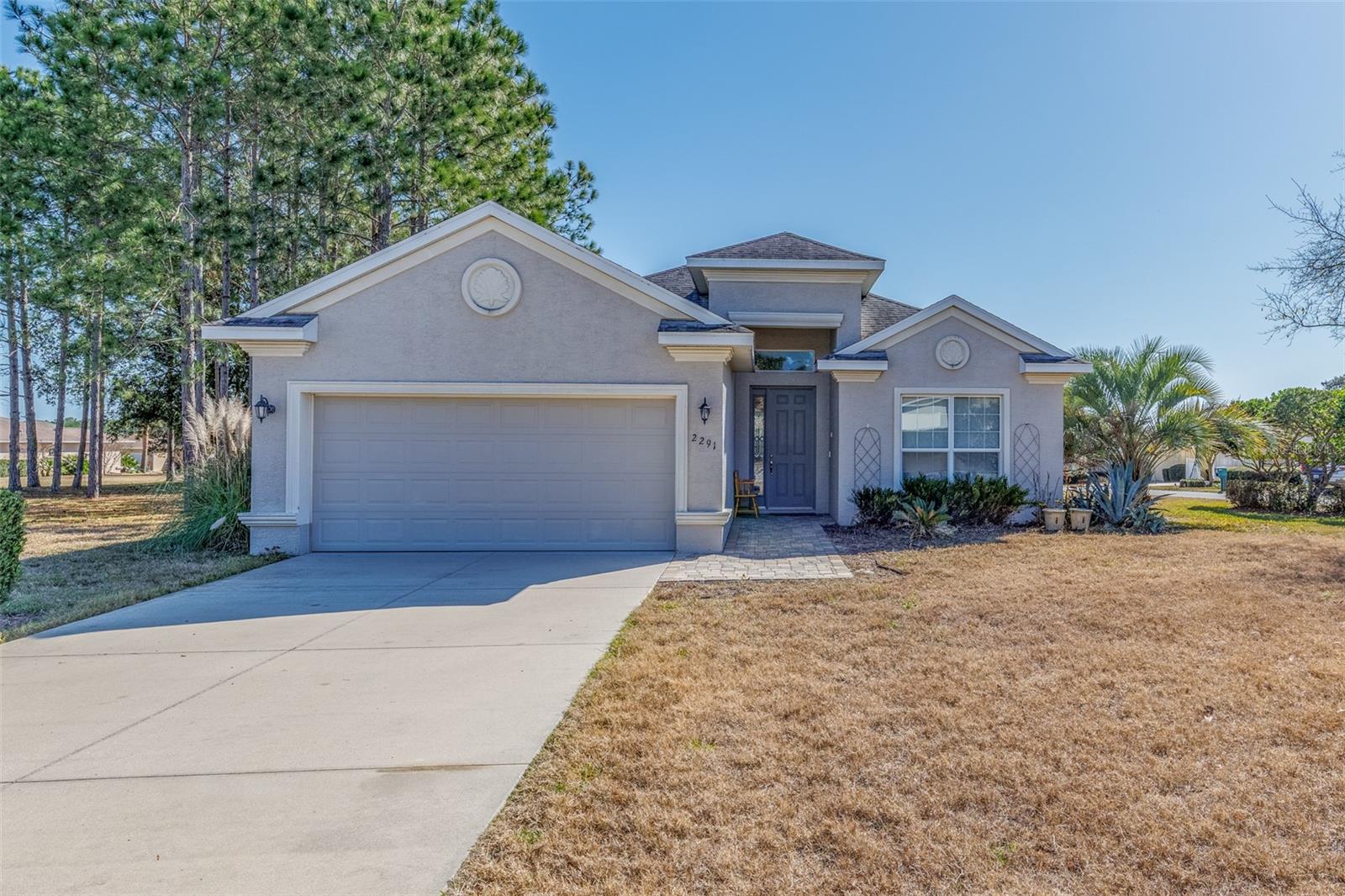 The best of Country Club style living is yours to enjoy and experience.  This exquisite home built in 2016 is absolutely gorgeous.  The kitchen is a chefs dream with custom wood cabinets and beautiful Cambrie countertops that provide durability , and a bright cheerful look.  Newer stainless steel top of the line appliances for you to enjoy your cooking experience. The chef of the house can mingle with guests while overseeing the delicious treats that are served. This 3 bedroom 2 bath villa/home also features a large great room and a 26 by 11 screened lanai with a great view of the many birds that grace your spacious back yard.  If you like to entertain this plan is ideal for that purpose.