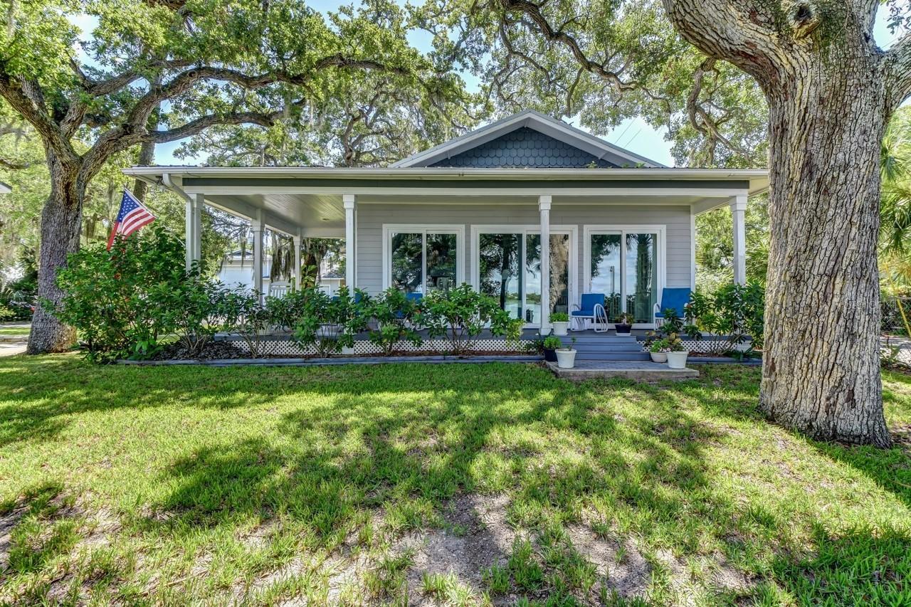 120 ft of direct intracoastal waterfront property, sub dividable mixed use zoned "off Flagler" property with riparian rights. 0.62 acres fenced with mature trees, a dock and 3 structures as follows: Newest home is a yr 2015 frame direct intracoastal 3 bed 2 bath with a wrap around front covered porch and back covered porch. It is situated within a hammock of towering oak trees and it features a waterfront living room with coffered ceilings, an open floor plan and bamboo floors. The second structure a block/frame, is the old "Mr Ryan's" fish camp home year 1953 direct waterfront where the fisherman docked his "Margaret A" fishing boat (named after his wife). It is a bit older structure that could use updating. It is a 2 story structure with an old built in walk in refrigerator cooler on the first floor. The third structure is a combination 48 ft RV garage/ garage/ workshop with half bath, it has a 12x14 roll up RV garage door, blown in icyene insulation , 200 amp service. This mixed use property if divided  has lot requirements width of 50 feet, a 20 ft front yard, 10 ft rear yard set back and 42 ft max height(refer to mixed use zoning) allowing apartments, B&B, multifamily, restaurants, hotels and more. Columbus Ave is a peaceful quiet area half block to Flagler Ave area shopping & restaurants and a 4 block walk to the beach. After a long day's work it is a perfect location to enjoy an afternoon cool beverage while watching passing boats and dolphins. ;Water: City
