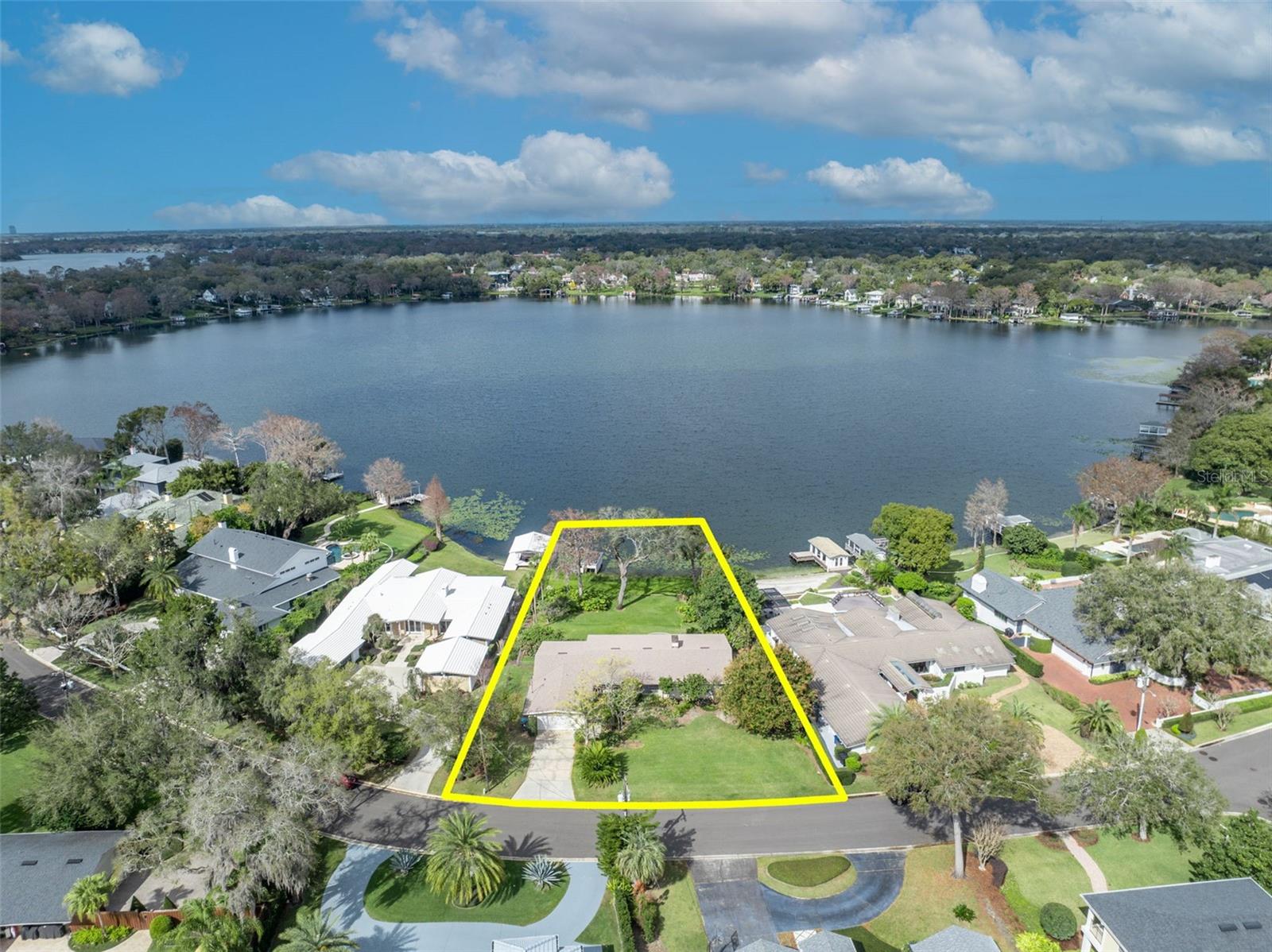 This single-story home offers serene lakefront living with approximately 95 feet of prime water frontage on beautiful Lake Osceola. Whether you enjoy watersports, boating, or simply relaxing by the water, this property can provide the true joy of lakefront living. The grandfathered boat dock provides a rare opportunity for transformation, perfect for customizing your ideal lakeside retreat. The home boasts breathtaking lake views from the primary retreat, family room, dining room, and Florida room, providing a seamless connection to nature. Upon entering, you're greeted by a spacious living room that flows effortlessly into the family room. Adjacent to the living room is a formal dining room, ideal for entertaining guests. The expansive primary retreat has dual closets. Across from the primary, a generously sized bedroom features its own ensuite bathroom. The kitchen, located off the dining room, also captures stunning views of the lake, making it a delightful space. An additional bedroom with an ensuite bathroom provides privacy and comfort, while a half bath is conveniently located near this bedroom. A second half bathroom is situated in the garage. A recent update includes a new roof installed in 2022. The property spans .61 acres, providing plenty of room for future development. Located on one of Winter Park's most beautiful streets, this home is just a short walk from the charming shops and restaurants of Park Avenue and Rollins College. Experience the best of lakeside living and the vibrant Winter Park community from this stunning property. Opportunity awaits the buyer of this gorgeous property!