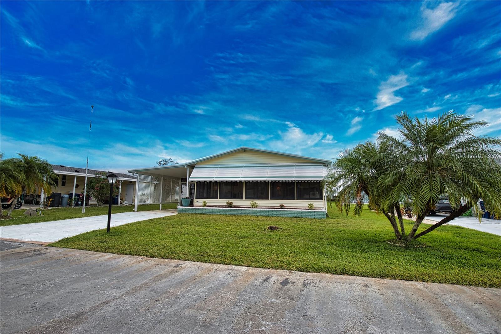Step inside this captivating 2-bedroom, 2-bath gem, where an open floor plan greets you. The remodeled kitchen shines with a pantry, a skylight that bathes the space in natural light, modern appliances, and a convenient pass-through window that connects to the cheerful Florida room. The elegant dining room features a built-in hutch, while the living room, with its sliding door, opens to a sprawling acrylic-enclosed Florida room measuring 10' x 24', adorned with front awnings and a door leading to the carport.  Retreat to the primary bedroom, which includes both a walk-in closet and an additional spacious double closet. Its remodeled dressing area features a stylish double-sink corner vanity and a dedicated dressing table, complemented by a solar tube skylight for an inviting ambiance. The primary bath boasts an indulgent walk-in shower and elegant luxury vinyl flooring.  The guest bedroom, complete with a generous walk-in closet, offers a comfortable retreat. The beautifully updated guest bath showcases a new vanity top, a new commode, luxurious vinyl flooring, and a delightful solar tube skylight. A handy linen/utility closet is conveniently located in the hallway.  With luxury vinyl flooring and new subfloors throughout the kitchen, dining room, hallway, and partially in the living room, this home exudes both style and comfort. The newly replaced windows enhance the brightness, while the vaulted ceilings in the kitchen, dining room, living room, and primary bedroom create a sense of openness and elegance.  Recent upgrades ensure peace of mind, including a new water heater (October 2022), a new electrical panel box (December 2018), and a new AC unit (July 2022). The property's well-planned enhancements also involve replaced tie downs, new vapor barrier, and floor insulation just completed in 2025, along with a humidistat and ceiling fans for added comfort.  Outside, a beautifully painted concrete driveway leads you to a spacious screened lanai and a utility room equipped with a washer, dryer, and ample storage. With a host of thoughtful upgrades and charming features, this lovely home is your ticket to tranquility on a picturesque street in La Casa. Discover the ultimate lifestyle on Florida's stunning Gulf Coast, perfectly nestled between the vibrant communities of Sarasota and Fort Myers, with convenient boat access to the sparkling waters of the Gulf. Welcome to La Casa, a serene 55+ community that boasts 974 charming homes, enveloped by lush native trees and beautiful common areas that showcase eight delightful lakes. Embrace the Good Life!  This vibrant community offers abundant recreational opportunities, including two inviting clubhouses and two heated pools, ensuring there’s never a dull moment for residents seeking both relaxation and adventure.  Embrace your dream lifestyle today!