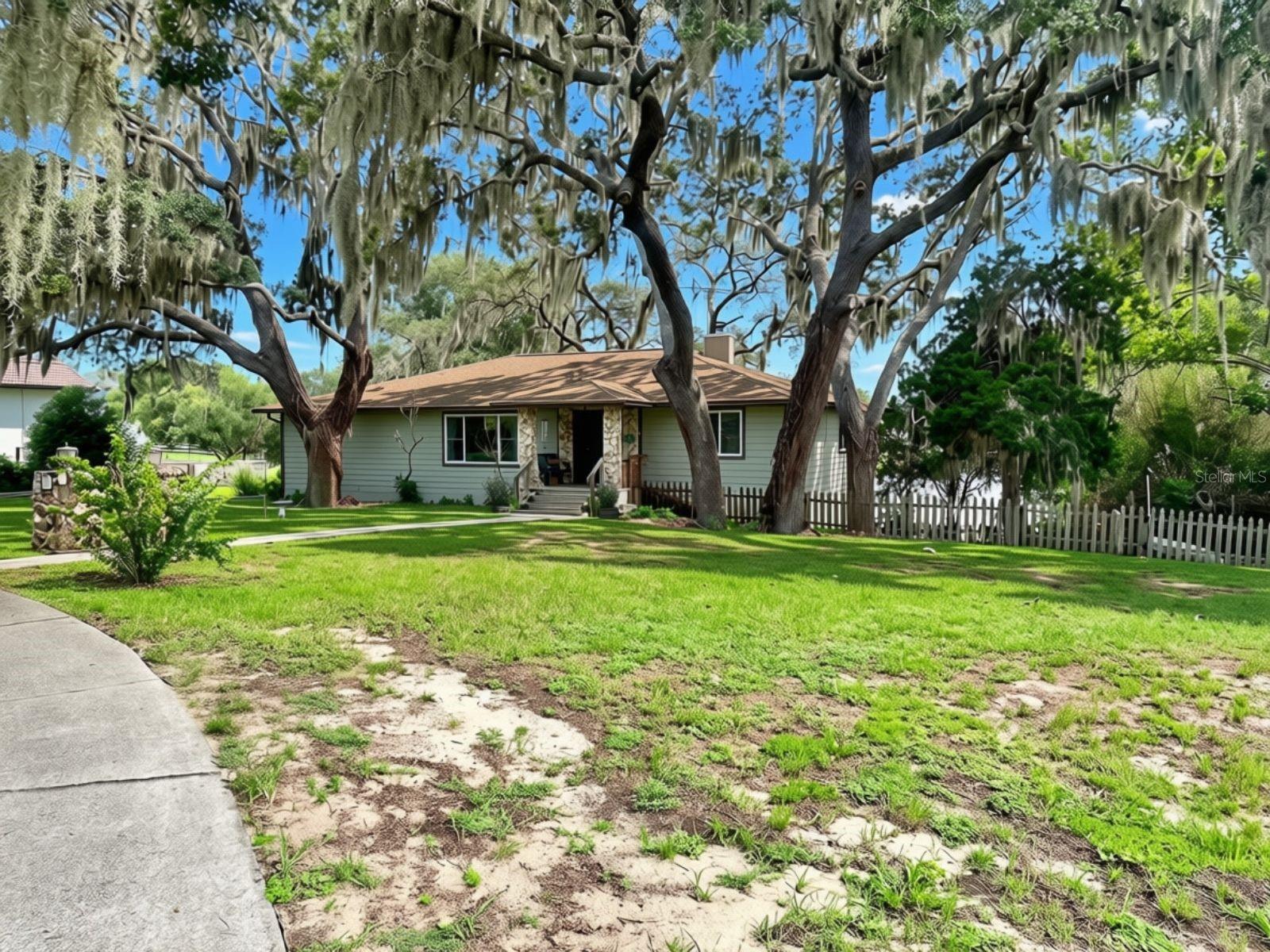 Discover the rare combination of space, privacy, and waterfront living at 10844 Poinciana Drive in Clermont. Nestled on a scenic 0.90-acre lakefront lot overlooking Little Saw Mill Lake with canal access to Saw Mill Lake, this exceptional split-level home offers endless possibilities for everyday living, entertaining, and enjoying Florida's natural beauty.

With 3,528 square feet of living space, the thoughtfully designed floor plan features 3 bedrooms and 2 bathrooms on the main level, creating comfortable day-to-day living, while the expansive lower level provides incredible flexibility. Complete with a spacious living area, kitchenette, and full bathroom, this versatile space is ideal for an in-law suite, guest accommodations, a recreation area, home office, or multi-purpose living space.

The home's outdoor spaces are just as impressive. Expansive upper and lower rear porches provide the perfect setting to take in tranquil lake views, sip your morning coffee, unwind at sunset, or host gatherings surrounded by nature. The nearly one-acre property offers room to spread out, garden, play, or simply enjoy the peaceful waterfront setting.

Additional highlights include a two-car garage, no HOA, and direct access to two connected lakes for boating, skiing, fishing, kayaking, paddleboarding, or simply embracing the waterfront lifestyle.

If you've been searching for a property that combines generous living space, flexible design, and a picturesque lakefront setting, this Clermont home is one you won't want to miss. Schedule your private showing today and experience everything this unique waterfront property has to offer.