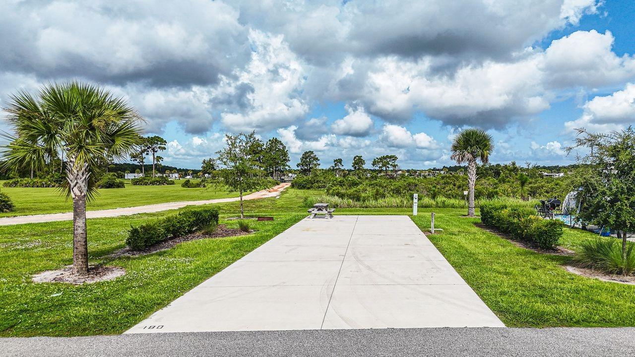 Rare opportunity to own a premium perimeter RV lot in Resort at Canopy Oaks — one of Central Florida’s most sought-after luxury RV resorts. Lot 180 is ideally positioned in the rear of the community with only one neighboring lot, offering tranquil nature preserve views, exceptional privacy, and direct access to scenic trails leading to the dog park and Picnic Island.

The generous 20’ x 70’ concrete pad with full 20/30/50 amp hookups easily accommodates Class A and Class C motorhomes, fifth wheels, travel trailers, or a small park model — making it a perfect seasonal escape or extended-stay retreat.

Ownership includes access to 435 acres of gated resort amenities, including a tropical tiki bar with live music, resort-style pool and spa, putting green, pickleball courts, and beautifully maintained grounds designed for relaxation and recreation. Enjoy the flexibility of personal use or participate in the professionally managed rental program to generate income when you’re away.

Perimeter lots with preserve views and this level of privacy are limited. Developer incentives are currently available, adding even greater value to this exceptional offering. Secure your place in this premier resort community before this opportunity is gone.