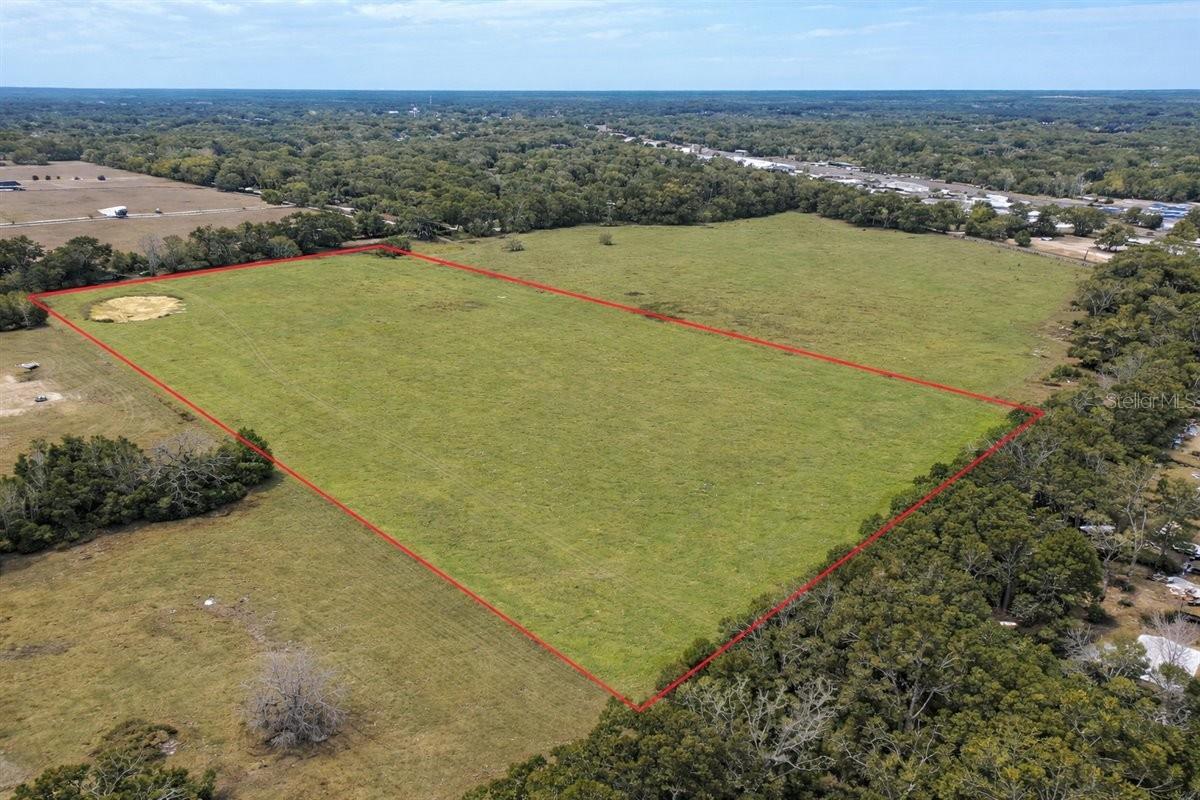 Rare opportunity to own acreage inside the city limits of High Springs, Florida. Buy all 20 acres or choose one of two proposed 10-acre parcels, offering flexibility to fit your vision! A unique blend of space, location, and future potential and conveniently situated just off Hwy 441, this property offers quick access to town while still providing the privacy and flexibility of a large land holding.
The acreage is fully fenced and gated, with an agricultural exemption currently in place to help keep property taxes low. Zoned R-1 (residential), it presents the perfect setting for a private estate, homestead, or custom single-family home. This property offers room to roam, garden, and enjoy the natural beauty of North Florida. And with no HOA, buyers have the freedom to truly use the land to fit their vision, a major advantage for those seeking flexibility and fewer restrictions.
Beyond its immediate residential appeal, this property also offers tremendous long-term upside. Its location within city limits and proximity to major roadways make it a compelling candidate for future development potential (buyer to verify zoning, land use, and subdivision possibilities with the City of High Springs).
Whether you envision building your dream home, creating a family compound, holding as an investment, or exploring development opportunities, this land is truly a blank canvas in one of High Springs’ most desirable and growing areas.