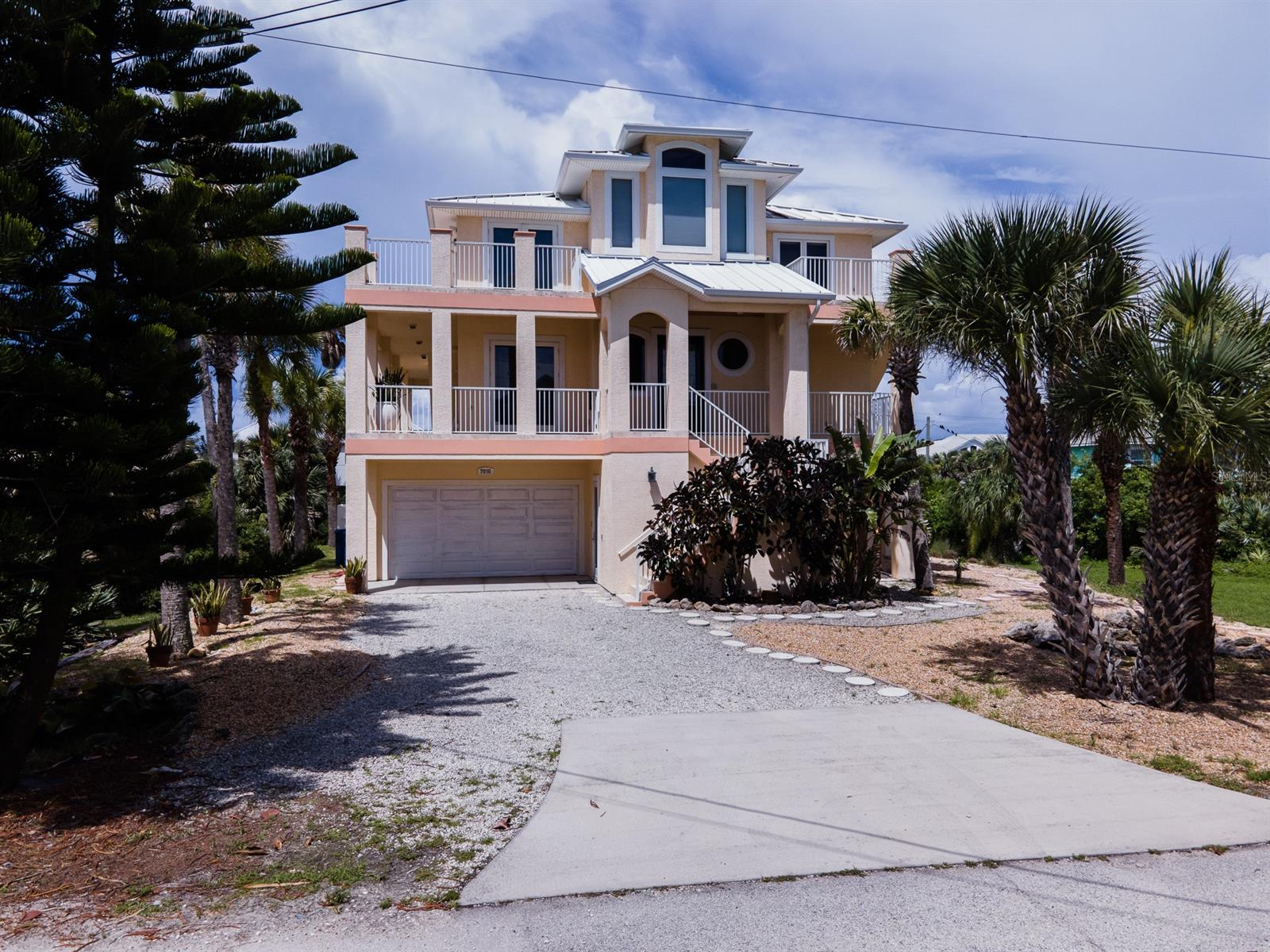Ocean View and River View from this spectacular oceanside home located in the south beach area of New Smyrna Beach. No driving on the beach area. This house is just steps away from the public beach walkover. Open floor plan perfect for entertaining. Built in 2005 with impact resistance doors and windows. State coded window tint for turtle preservation. Propane tank underground. First level has a large family room/entertainment room. There is also a laundry area along with a full bath with shower. The doors from this area lead to the inground screened in 14"X28" freeform pool.  As you walk thru the  front door made of  4X8 solid mahogany with beveled glass you are greeted by a large foyer with 30' ceilings and ornate lighting, Brazilian cherry wood flooring. The living area opens up to a large kitchen with breakfast bar, island, Thermador stove/oven, wine cooler, wood kitchen cabinets and all looks out onto a wrap around deck with beautiful views of the river. This level has two bedrooms, one and one half bath. The third level has two master suites and  a laundry room. Walk out onto the spacious decks from each bedroom and enjoy the views of the river sunsets. Walk around to the front of the house from the west deck to have a view of the ocean. The home is just a few blocks north of the Canaveral National Seashore. ;Water: City