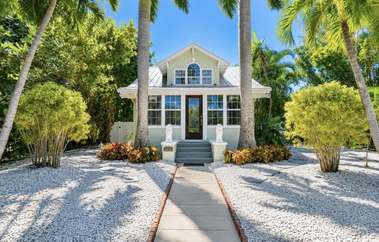 Welcome to your own private Don Cesar Place tropical oasis in the heart of St. Pete Beach! Tucked away on an oversized, lushly landscaped lot, this beautifully updated 3-bedroom, 2-bath main residence is paired with a large and separate 1-bedroom, 1-bath guest house, creating the perfect coastal retreat for family, guests, multigenerational living, or additional income potential.

Rich with Old Florida character, this property was originally developed by the Don Cesar’s own Thomas Rowe. The main home features original architectural details, an inviting fireplace, abundant natural light, and spacious living areas that seamlessly blend timeless charm with modern updates. The remodeled kitchen showcases shaker cabinetry, stone countertops, stainless steel appliances, and opens to the dining and living spaces, making it ideal for entertaining. Upstairs, the oversized primary suite offers a private retreat complete with an en-suite bath, bonus room, and generous closet space.

Step outside into your own boutique resort-style backyard where a sparkling pool is surrounded by mature tropical landscaping, creating exceptional privacy and the perfect setting for relaxing or entertaining. The detached guest house provides its own living space, kitchen, bedroom, bath, and laundry room, making it ideal for visitors, extended family, or private home office.

Located just minutes from the sugar-sand beaches of St. Pete Beach, waterfront dining, marinas, shopping, and everything the Gulf Coast lifestyle has to offer, this unique property offers the rare combination of character, flexibility, and outdoor living that's increasingly difficult to find.

Whether you're searching for a primary residence, vacation home, or investment opportunity, this one-of-a-kind tropical turn key compound is ready to impress.