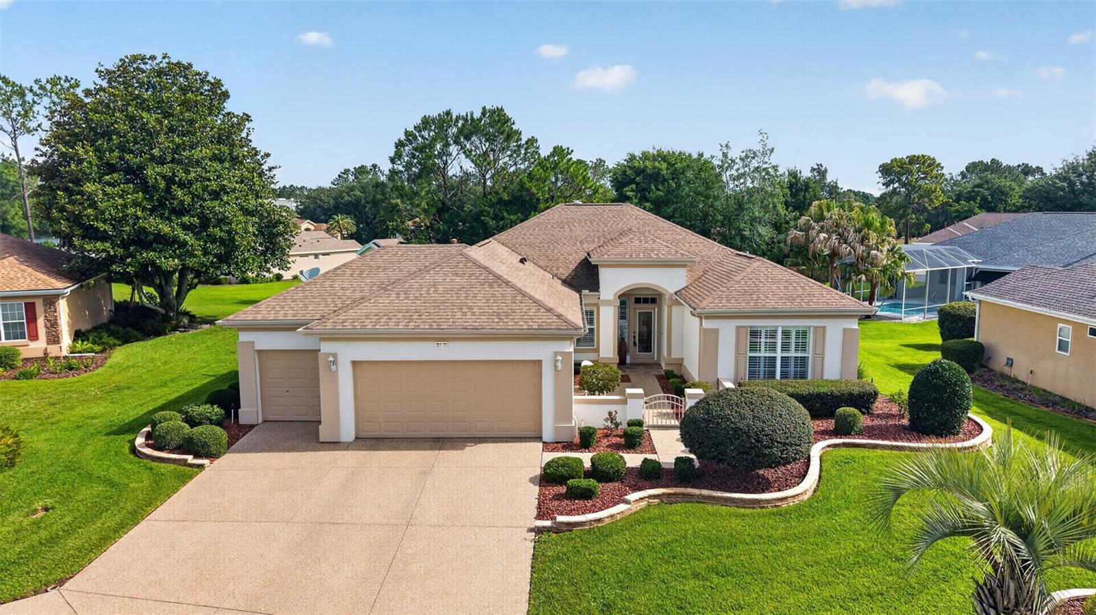 DON'T MISS this well-maintained 2-bedroom, 2-bath Madeira floor plan with a golf cart garage, situated on a Huge semi-private lot with relaxing views in the highly sought-after 55+ premier golf community of Del Webb Spruce Creek Golf & Country Club.
This beautiful home offers exceptional curb appeal with stacked-stone landscape walls and a welcoming courtyard entry leading to an elegant leaded-glass front door. Inside, you’ll find crown molding, plantation shutters, and tile flooring throughout the home "NO CARPET".
The updated kitchen features Maple cabinets, Corian countertops, stainless-steel appliances, recessed lighting, and a comfortable breakfast nook for casual dining.
The spacious primary suite includes crown molding, a large walk-in closet, and a bow window for added space and natural light. The ensuite bath offers dual sinks and a walk-in shower. The guest bedroom and bath are equally impressive, featuring crown molding.
Additional highlights include an extended garage with extra storage space, a golf cart garage, a brand-new 2025 HVAC system, a gas water heater, and a roof re-shingled in 2014. Save money with a shared irrigation well.
Enjoy the enclosed climate-controlled Florida room, offering comfortable year-round enjoyment and additional living space not included in the stated square footage. Designed for entertaining, the open floor plan flows seamlessly into this inviting space, perfect for relaxing and enjoying Florida living while taking in the peaceful semi-private views.