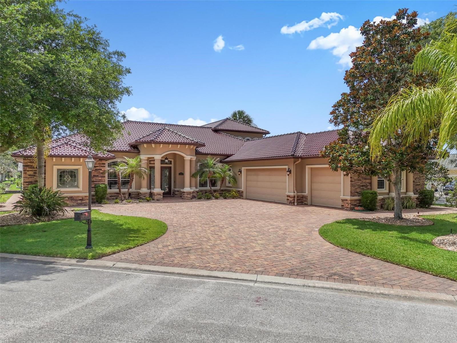 Waterfront Luxury in The Sanctuary — Protected Harbor; NO WAKE ZONE. This impressive 5-bedroom, 4-bath canal-front estate with boat cabana offers deep-water access just 6 residences off the Intracoastal Waterway, making it ideal for large boats and the ultimate Florida boating lifestyle. Designed for entertaining and everyday comfort, the home features soaring tray ceilings, pocket sliders framing beautiful canal views, a spacious eat in kitchen with granite countertops, travertine tile, stainless appliances, walk-in pantry, and a game room complete with a full bar.
The private primary suite offers a spa-inspired bath with a large walk-in shower, bidet, abundant storage, and a walk-in closet that doubles as a safe room. Upstairs, guests will enjoy two additional bedrooms, a full bath, a second living area, and a balcony overlooking the water.
Step outside to your resort-style lanai featuring a full outdoor kitchen with grill, smoker, and cooktop, plus a heated spa/splash pool surrounded by tropical landscaping. Boaters will appreciate the private dock with 16,000-lb lift and easy access to the Intracoastal. Additional highlights include a self-cleaning glazed tile roof imported from Portugal, whole-house generator, three newer HVAC systems, private irrigation well, and a high elevation with no flood history. Located within Palm Coast’s premier gated community, just minutes from shopping, dining, golf, and the beach.
