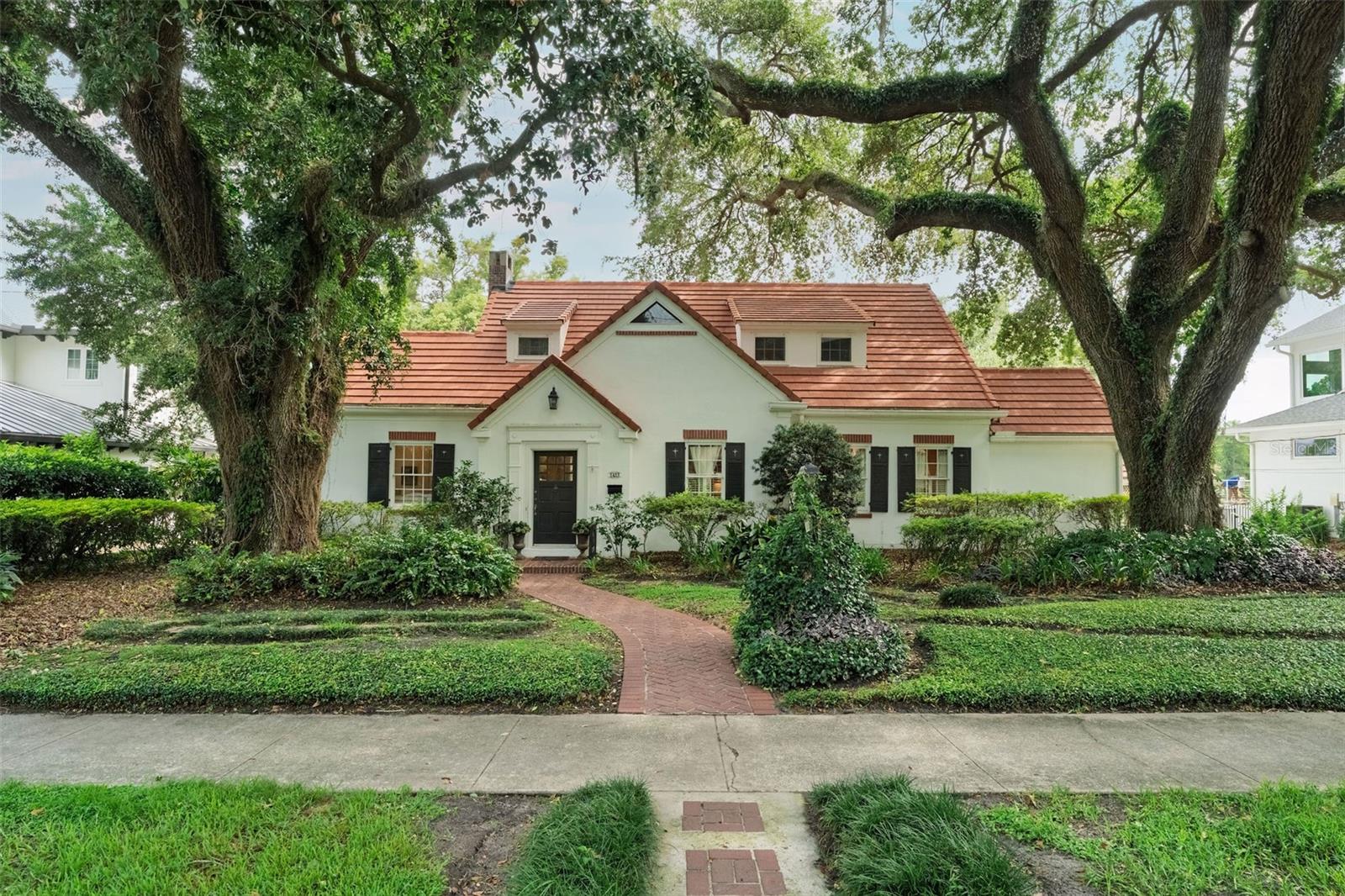 Nestled on a majestic oak lined street in one of Orlando’s oldest and most beautiful neighborhoods, this exceptional 5 bedroom, 3 bath home blends timeless 1937 charm with an unbeatable lakefront lifestyle.  Set on an impressive 105 feet of pristine frontage on Lake Lancaster, the property offers  water views and a rare sense of privacy.  Rich character shines throughout w original hardwood floors, masonry fireplace and the enduring beauty of a concrete tile roof (2016).  Outside your private resort awaits with a sparking pool, heated jacuzzi, picturesque  surroundings and a large deck over the water designed for entertaining and peaceful everyday living.  Cedar closets, attic storage, cellar  and a full house generator combine to make this a truly unique property.  This is a rare opportunity to own a special home.  Come and make it your own!  
Roof -2016   AC upstairs -2020   Rewired-2019