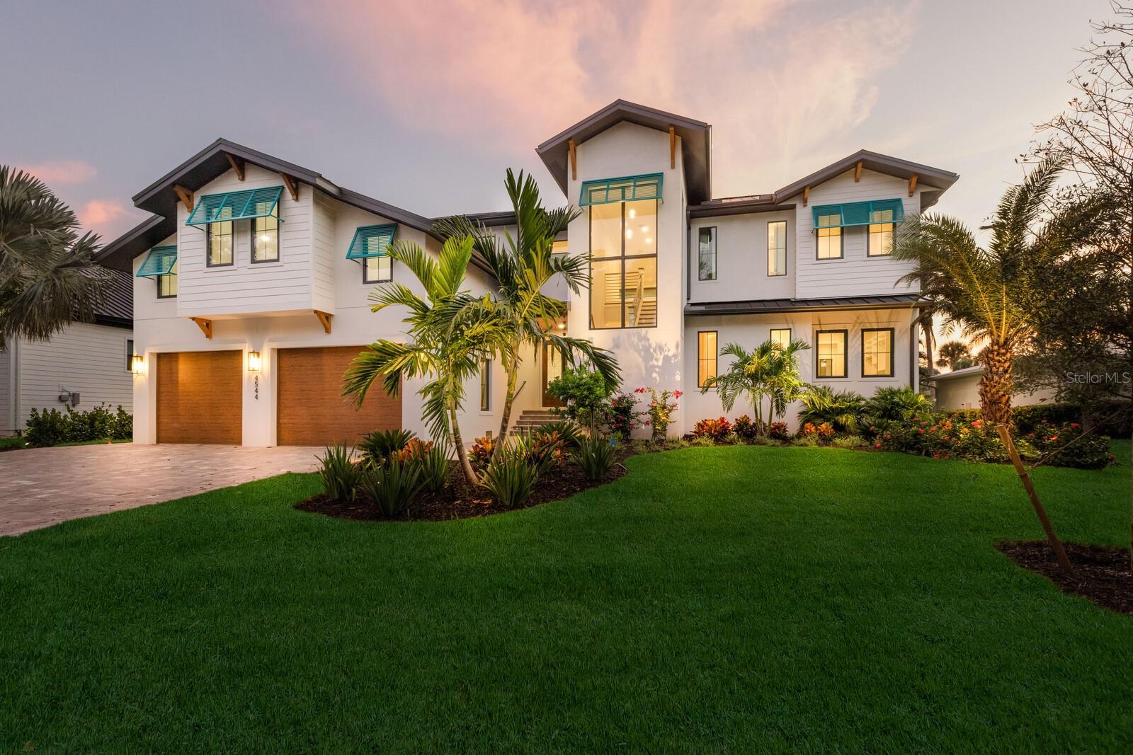 One or more photo(s) has been virtually staged. Welcome to a brand-new coastal masterpiece that redefines luxury living on world-renowned Siesta Key. Designed with both sophistication and comfort in mind, this waterfront retreat blends timeless architecture with modern amenities, all just moments from Siesta Village and the powdery sands of Siesta Beach. Inside, soaring ceilings and walls of glass bathe the home in natural light, while light wood floors bring warmth and elegance throughout. The heart of the home is a double-island chef’s kitchen, complete with premium appliances, custom cabinetry, and a generous walk-in pantry—perfect for both intimate family meals and grand entertaining. This residence offers four en suite bedrooms, including two primary suites (one upstairs and one downstairs), providing flexibility and privacy for family or guests. An additional private office and 600± SF of unfinished space above the garage present endless possibilities for customization. Seamlessly integrated indoor and outdoor living spaces create a true resort-style atmosphere. Step outside to enjoy multiple balconies, a pool and spa overlooking the water, a fully equipped outdoor kitchen, and a dedicated pool bath. For the boating enthusiast, this property features two boat lifts and quick access—just five minutes by water to the open bay. The location at the end of a quiet dead-end street ensures both serenity and privacy, with the added bonus of no homes directly across the canal, offering wide and peaceful views. This is more than a home; it’s a statement of waterfront luxury and the perfect canvas for your Siesta Key lifestyle. Days on market shows from pre construction.  Certificate of occupancy issued September 2025.