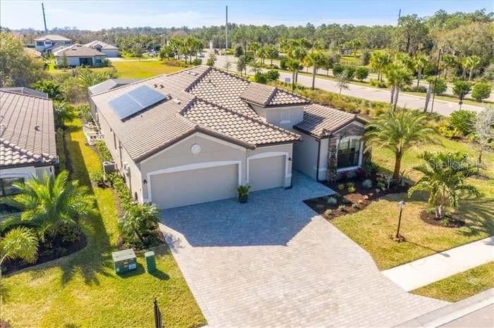 Welcome to luxury living in the highly sought-after gated community of Polo Run at Lakewood Ranch. Perfectly positioned on an expansive corner lot adjacent to the community dog park, this meticulously upgraded Summerville model offers 3 bedrooms, 3 full baths, a private den, and an oversized 3-car garage featuring custom marbled metallic epoxy flooring with a luxury showroom-quality finish. Combining elegance, comfort, and resort-style amenities, this exceptional residence delivers the ultimate Florida lifestyle.

A grand double-door entry welcomes you into a bright, open-concept floor plan enhanced by soaring tray ceilings, crown molding, and beautiful wood-look porcelain plank tile flooring throughout. Expansive three-panel sliding glass doors seamlessly connect the interior living spaces to an extraordinary outdoor retreat designed for both entertaining and everyday enjoyment.

At the heart of the home, the chef-inspired gourmet kitchen is designed to impress, featuring premium solid-surface countertops, an oversized center island, designer tile backsplash, stainless steel appliances, abundant cabinetry, and a spacious walk-in pantry. The open-concept design flows effortlessly into the dining and great room areas, creating an inviting atmosphere for entertaining family and friends.

Step outside to your private backyard oasis overlooking a serene preserve backdrop. The contemporary resort-style pool serves as the centerpiece of the outdoor living space, complemented by beautiful water features, a spectacular 10-person infinity-edge spa, gas fire features, and a panoramic screened enclosure. The fully equipped outdoor kitchen, complete with a gas grill, kegerator, and mini refrigerator, creates the perfect setting for hosting guests or enjoying peaceful Florida evenings while taking in the tranquil views.

The luxurious owner’s suite serves as a private retreat, offering peaceful preserve views, dual walk-in closets, and a spa-inspired ensuite bath featuring dual vanities and a spacious walk-in shower. Two additional guest bedrooms and a private den provide flexibility and comfort for family, guests, or a home office.

The oversized three-car garage offers ample room for vehicles, storage, and hobbies while showcasing the stunning custom metallic epoxy flooring, a rare upgrade that combines durability with striking visual appeal.

Residents of Polo Run enjoy access to an impressive collection of resort-style amenities, including a clubhouse, fitness center, resort pool, pickleball and tennis courts, basketball courts, playground, and scenic walking trails. Adding even greater value, the community’s solar energy program helps promote energy efficiency and lower utility costs.

Ideally located near top-rated schools, championship golf courses, upscale shopping, dining, and everything that makes Lakewood Ranch one of Florida’s premier master-planned communities, this exceptional home offers luxury, convenience, and an unparalleled lifestyle.