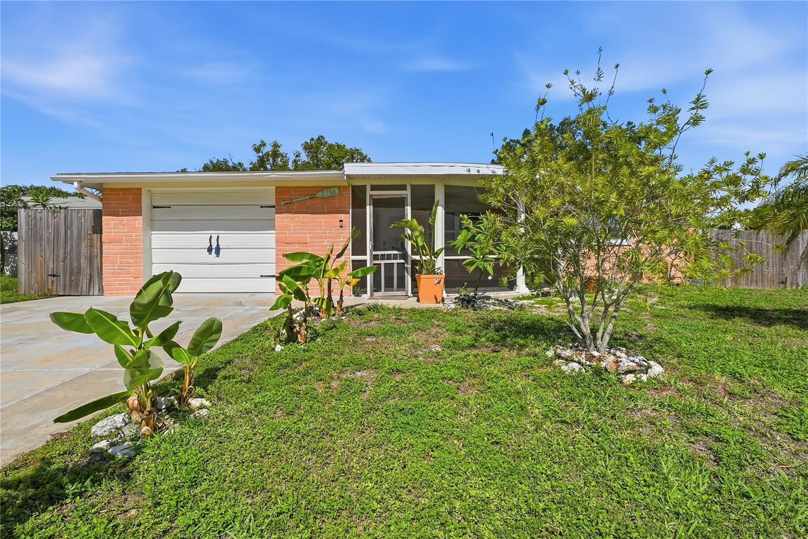 Welcome to 2704 Lawn Place, a well-maintained and thoughtfully updated 3-bedroom, And Bonus room, 2-bath home offering flexibility, comfort, and plenty of possibilities. With no HOA restrictions, this property is a great fit for homeowners, investors, or anyone looking for additional living space with income-producing potential.

Inside, you'll find numerous updates that make this home truly move-in ready, including updated windows, a tankless water heater installed in 2020, and major improvements such as a roof and air conditioning system replaced in 2019. The functional layout provides comfortable everyday living while offering versatility to meet a variety of needs.

One of the home's most attractive features is the separate living area created from the converted garage. Complete with its own entrance and kitchenette, this space can serve as a private guest suite, in-law quarters, home office, or rental opportunity(buyer to verify county restrictions).

The outdoor space is designed for enjoying the Florida lifestyle, featuring an enclosed patio, gazebo, outdoor shower, covered storage area, and a fully usable backyard with room to relax or entertain.

Solar panels help improve energy efficiency and lower utility costs. Buyers have the option to assume the current solar lease agreement with payments of approximately $171 per month, plus an average Duke Energy connection charge of about $30 per month, though assumption is not required.

To make the purchasing process even easier, home insurance and flood insurance quotes are already available for prospective buyers. Conveniently located near shopping, restaurants, parks, Gulf Coast beaches, and major commuter routes, this property offers a combination of flexibility, functionality, and value that is difficult to find at this price point. Schedule your private showing today.