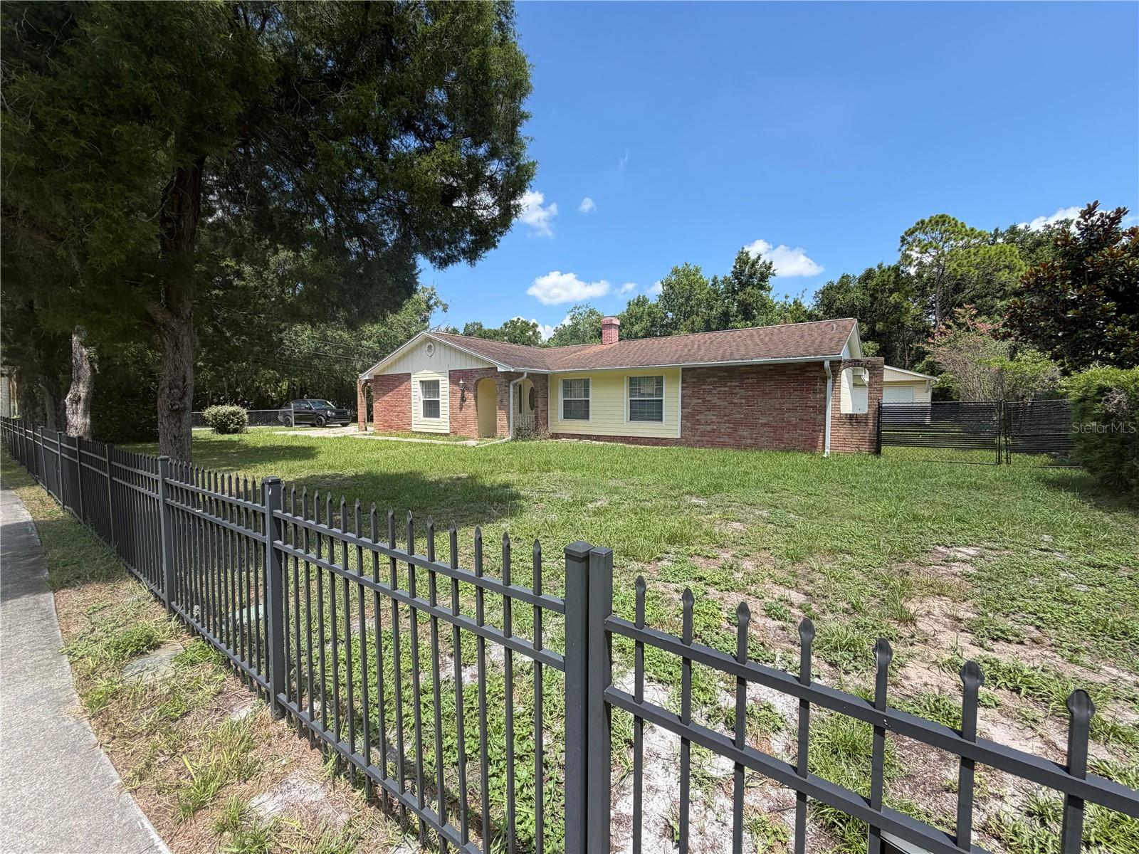 EXPECT TO BE IMPRESSED IN THIS CHARMING POOL HOME ACROSS THE STREET FROM LAKE PRICE!  Welcoming you & guests is a large corner lot with walk-ways enhanced with mature trees and an attractive brick curb appeal. Sit back and relax in this easy, low maintenance home, desirably located in a peaceful community with NO HOA. Open the front door & you’re invited into an split bedroom floor plan with neutral colors and all living areas, a spacious family room and a large enclosed Florida room offering comfortable space for everyday living, relaxing & entertaining! Indoor and outdoor space combine perfectly, inviting you to enjoy delightful views and savor Florida living at its very best. There’s plenty of room for easy living in this generously sized 3 bedroom, 2 bathroom, 2 car garage home offering just over 1,600 sq. ft. of quality finishes throughout. The open kitchen boasts plenty of counter space, stainless steel appliances and a breakfast bar. Next to the kitchen you’ll find a large, comfortable eat in nook & French doors leading to a spectacular outdoor living area – your own backyard paradise all yours to enjoy privately or with a crowd! Sit outside, have a glass of wine and listen to the birds while overlooking your nice, private yard all fenced in. Spacious master bedroom with a walk-in closet and a separate walk in shower. Designer features include; a newly resurfaced pool with a huge screened in porch, a detached garage and an additional room that could be converted to an outside bathroom in the future. Wood flooring in the living room and tile delivering good looks, easy upkeep and a thoughtful open plan layout ensures that everyone will have their personal space. Great location close to major highways, nightlife, restaurants and shopping.