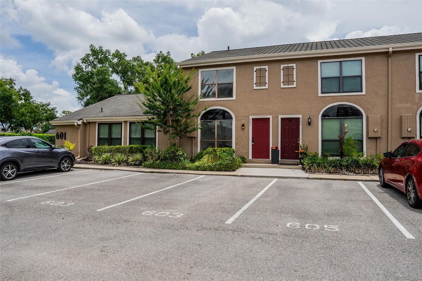 Step inside and this townhome in Casa Park Villas that feels nothing like its neighbors. Completely renovated with designer finishes throughout, NEW AC system (2026), NEW hot water heater, luxury vinyl plank flooring throughout, doors, trim, kitchen, and all three bathrooms renovated. The kitchen sets the tone immediately with white shaker cabinets with matte black hardware, quartz countertops and full quartz backsplash, all-new stainless appliances, under mount sink with matte black faucet, and a breakfast bar pass-through that opens to the bright living and dining areas. Large windows flood the main level with natural light, and a slider leads to the screened rear porch overlooking open green space with pond views and no rear neighbors. Upstairs, both bedrooms are true primary suites with private en-suite baths - each one fully custom. The first features floor-to-ceiling dramatic black vertical tile in the tub/shower with a tiled niche and rain shower head, quartz vanity, and black-framed mirror. The second is an equally polished contrast: white vertical tile tub/shower, quartz vanity, glass pendant vanity light, and the same refined matte black hardware. Dark penny tile floors tie both bathrooms together. The powder bath downstairs features bold black-and-white geometric tile - a finishing touch that shows this renovation was done with intention, not budget cuts. Two assigned parking spaces sit directly in front. The community pool is steps away. Directly across the street: Trotwood Park with pickleball and tennis courts, a splash pad, basketball, playgrounds, pavilions, BBQ grills, and a scenic boardwalk over Lake Maria. Zoned for the A+ rated Seminole County School District, with Keeth Elementary and Indian Trails Middle School within walking distance. Minutes to Winter Springs Town Center, Oviedo Mall, SR 417, UCF, and downtown Orlando. Buyers have been waiting for the one that's actually been done right - this is it.