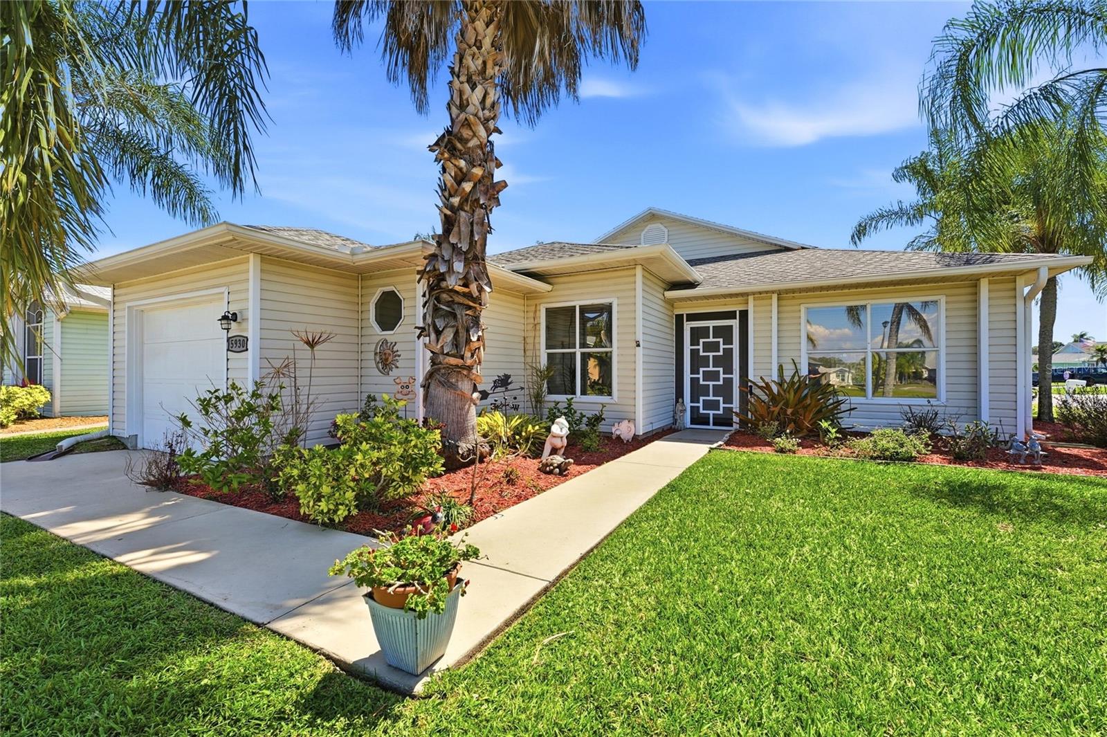 Priced to Sell! Corner Lot! Move in Now! Open and Spacious layout! 2- bedroom, 2 bath, 1-Car Garage situated in the active, Guard Gated 55+ community of Palm Grove off US Highway 1. Walk to Club House and Pool. Palm Grove, offers a variety of amenities including a Heated Pool, Low impact aerobics, Arts and Crafts, Tennis and Pickleball Courts, Bocce, Shuffleboard, Fitness Room, Clubhouse and more! The HOA provides Irrigation, Water/Sewer, Lawn Care, Cable TV, Internet, and a 24-hr. Manned Security Gate. (Note: Gate Clearance required for entry into Palm Grove.) 1,300 sq. feet of living space featuring Vaulted ceilings in the main Living areas. The
Kitchen features a Breakfast nook with Glass Sliders that open to the screened in Florida room. The kitchen offers plenty of cabinet space and a separate Formal Dining Room. The Owner’s Suite is tucked away in the back of the Home for more privacy features a
Walk-in Closet separated into a vanity area, private toilet and shower area. The Guest bathroom has a combination tub/shower, vanity and toilet. Laundry room is in the garage. The Primary Bedroom and Living Area features glass sliders that also open to the screened in Florida Room. Luxury Vinyl Tile in living room, dining room and hallway (2023), New Countertops (2023), New Water Heater (2025), AC/HEATER (2020). Conveniently located 15 minutes or less from the I-95/Turnpike, the Civic Center, Hospital, Local Beaches, Parks, shopping/restaurants, and so much more.