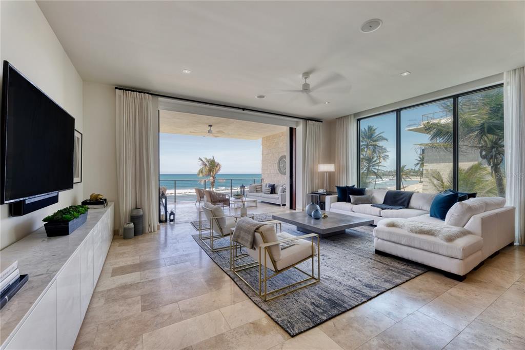 A true to form Contemporary Coastal design, residence 3831 in the newest construction at West Beach, elevates the luxurious backdrop of the Ritz-Carlton Reserve, Dorado Beach, to a completely unique experience. The primary suite with five-fixture custom standalone shower and soak tub, two additional en suite bedrooms, designer kitchen with exposure to a landscaped north-facing garden/beach/ocean, all offer extraordinary living and resting spaces with heightened volumes of natural light and style. 

Custom color palette on all doors and cabinetry, with matching gold and black fixtures throughout and upgraded light fixtures and mirrors are unique to this West Beach home, in its totality. Setting the tone of ultimate relaxation in this coastal contemporary, donned with white custom marble or porcelain slab countertops on all cabinetry, throughout. Matching RH fans upgrade ties the interior entertaining with the exterior living. 

From the porcelain farmhouse sink in the elegantly appointed kitchen to the curated light piece over dining designed by Lindsey Adelman, this design inspired West Beach home truly offers a one of a kind space, at this Caribbean beachfront locale.

The panoramic Northern view to the beachfront and the ocean are just as spectacular during the day as they are at sunset. With six spacious walk in closets and a hall linen closet, this unit boasts more than twice the closet space of all previous West Beach buildings. 

This beautiful apartment comes with the highly sought after in West Beach, private fully climate controlled garage.