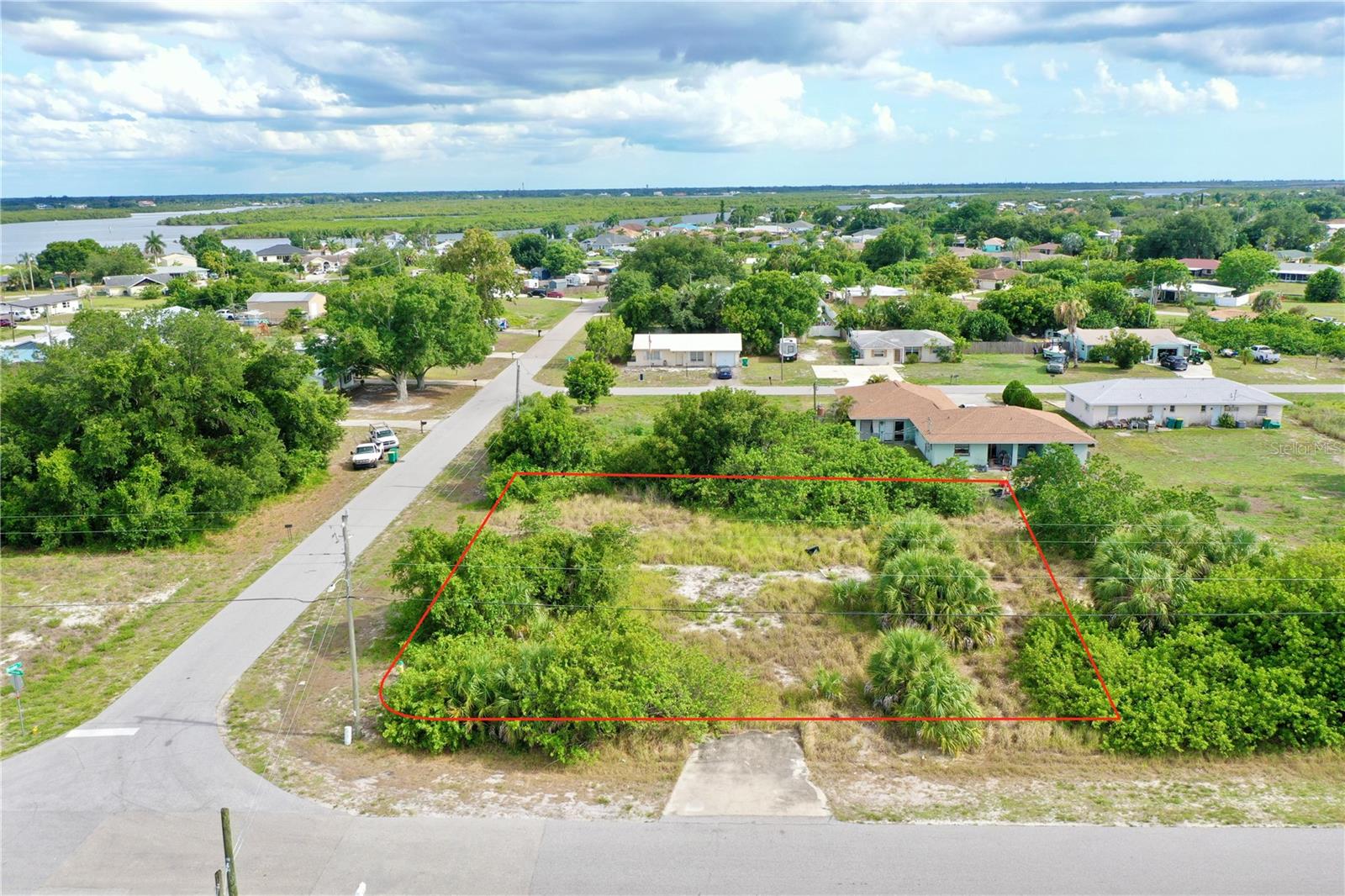 INVESTOR & BUILDER ALERT! This oversized 15,444 sqft (0.3545-acre) corner lot in Harbour Heights offers an exceptional MULTI-FAMILY development opportunity with 239ft of road frontage, prime exposure, maximum flexibility, and absolutely NO Deed Restrictions to limit your vision. Zoned RMF-10 (Residential Multi-Family, 10 units/acre), the property is perfectly positioned for an income-producing multi-unit investment build or a spacious, custom single-family home with plenty of room to spare. While the underlying high-density zoning designation ensures long-term equity and maximum land value, the physical dimensions of this specific parcel has a legal base density to build a high-demand duplex or triplex. Additionally, a future developer could potentially unlock higher density on the site by utilizing Charlotte County's Transfer of Density Units (TDUs) program. Situated in a highly desirable, high-and-dry location, the parcel sits securely within an "X" Flood Zone, meaning flood insurance is typically not required. Please note that a well and septic system are required to build on this site. Located just minutes from I-75, this location offers incredibly easy travel north and south throughout the state, making it highly convenient for commuters or tenants. For the boating enthusiast, the property sits right down the street from the Harbour Heights boat ramp, offering quick and effortless launching to cruise the scenic Peace River, head out into Charlotte Harbor, or spend the day exploring open Gulf waters. The area is also a paradise for avid golfers, with numerous pristine courses nearby; the highly rated Deep Creek Golf Course is just a few minutes away, and the impeccable  Aileron Golf Course is right around the corner, offering an affordable golf membership option for those wanting access to a truly premier, top-tier course layout. This is a rare chance for a builder or savvy investor to secure a versatile piece of Southwest Florida real estate, though the buyer is advised to verify exact building setbacks, total unit capacity, and final footprint configurations directly with Charlotte County zoning.