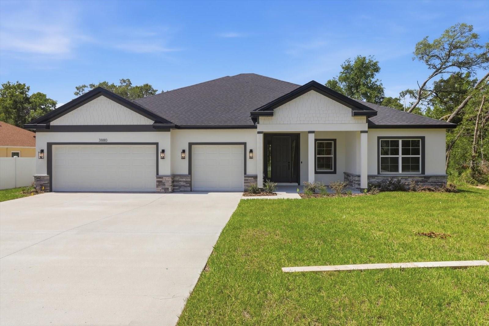 Ask about our Builder Incentives! High end luxury meets affordability in this stunning 4-bedroom 3-bathroom 3 car garage home situated on a central lot close to all things Ocala! Stand out features include Frost White Quartz countertops, designer tile selections in all the bathrooms, Samsung stainless steel appliances plus washer and dryer, 9'4'' ceiling & 8' doors throughout the entire home, LVP flooring throughout (NO CARPET), and so much more. From the moment you arrive you will notice the oversized 3 car garage driveway with ample parking and tasteful stacked-stone accents. Once inside, you will love the open floor plan with the living room, dining room and kitchen all flowing together in perfect harmony. The kitchen features 42'' upper cabinets, walk-in pantry, and an oversized island that is sure be the statement piece of this home. The Master suite is expansive with tray ceiling, dual sink vanity with makeup station, huge walk-in closet, and gorgeous seamless glass shower. Guest bedrooms are all very well sized with 2 bedrooms sharing a jack and jill bathroom with dual sinks. Indoor utility room with tons of natural light will make laundry your favorite chore. The secluded covered lanai is perfect for grilling or just relaxing with family and friends. This home won't last long, so schedule your private tour today before it's too late!