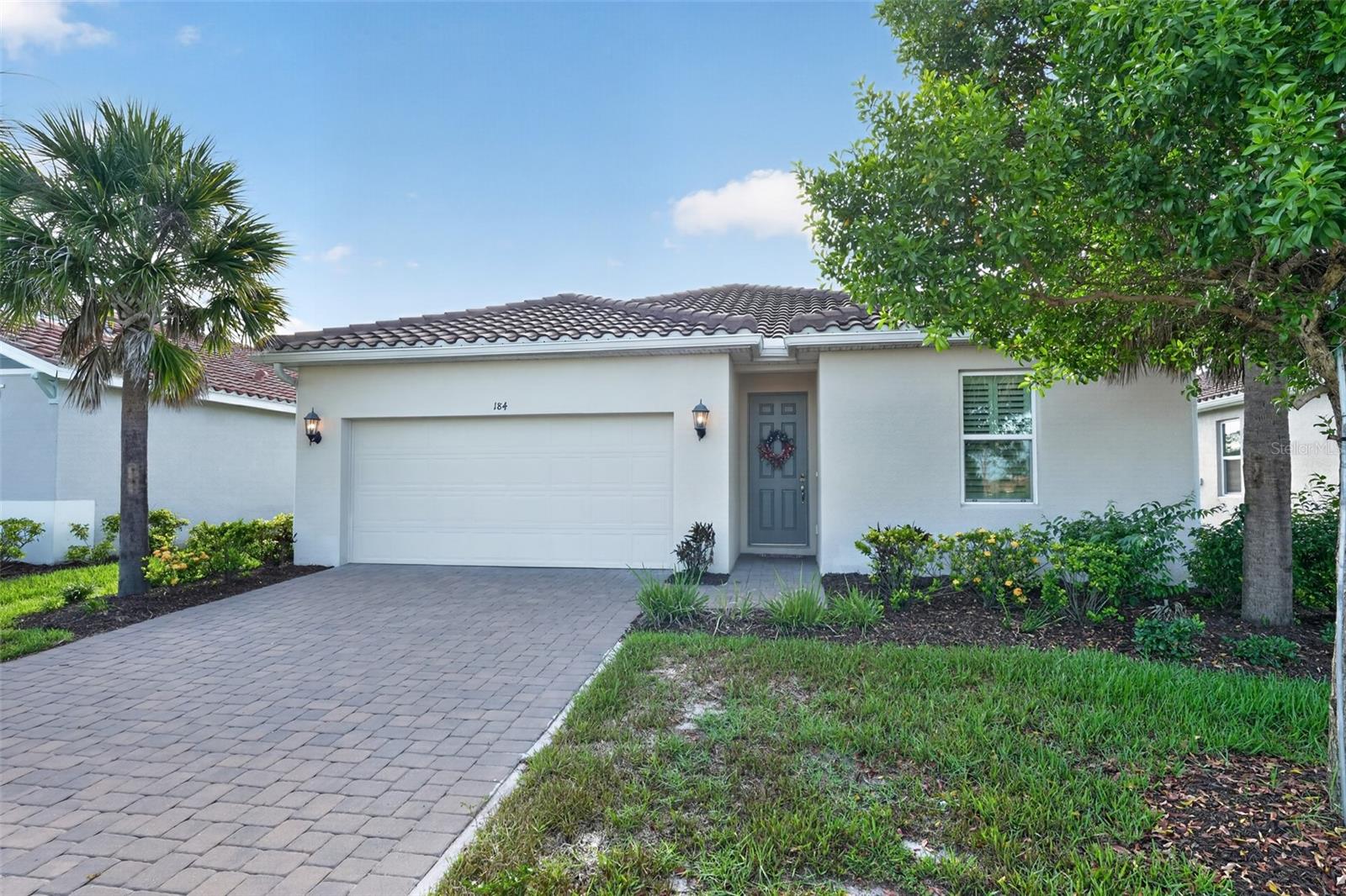 Welcome to 184 Daylily Boulevard, a beautifully maintained home located in the highly desirable gated community of Venice Woodlands in Nokomis. Combining modern comfort, resort-style amenities, and an exceptional location, this residence offers the perfect opportunity to enjoy the best of Florida living.

Step inside and discover a thoughtfully designed floor plan featuring bright, open living spaces ideal for both everyday living and entertaining. Large windows invite natural light throughout the home, creating a warm and welcoming atmosphere. Whether hosting family and friends or enjoying a quiet evening at home, this residence offers comfort, functionality, and style.

Venice Woodlands is a sought-after gated community known for its beautifully landscaped surroundings and impressive amenities. Residents enjoy access to a resort-style swimming pool, fitness center, clubhouse, pickleball courts, bocce ball courts, and walking paths throughout the neighborhood. The community provides a vibrant yet peaceful lifestyle with opportunities to stay active and connected.

One of the property's greatest advantages is its prime location. Just minutes away, you'll find the pristine Gulf beaches of Nokomis Beach and Venice Beach, where you can enjoy swimming, boating, fishing, paddleboarding, and spectacular sunsets. Outdoor enthusiasts will appreciate easy access to the renowned Legacy Trail, perfect for biking, walking, and jogging.

Nearby attractions include historic downtown Venice, known for its charming boutiques, outdoor cafés, waterfront dining, farmers markets, and year-round community events. Golf enthusiasts will find numerous championship golf courses nearby, while nature lovers can explore Oscar Scherer State Park, Casey Key, and the area's many parks, preserves, and waterways.

Conveniently located near shopping, dining, medical facilities, and major roadways, this home offers easy access to Sarasota, Venice, and all that Florida's Gulf Coast has to offer.

Whether you're searching for a year-round residence, seasonal retreat, or investment opportunity, 184 Daylily Boulevard offers the perfect combination of location, lifestyle, and community amenities. Schedule your private showing today and experience the Venice Woodlands lifestyle for yourself.