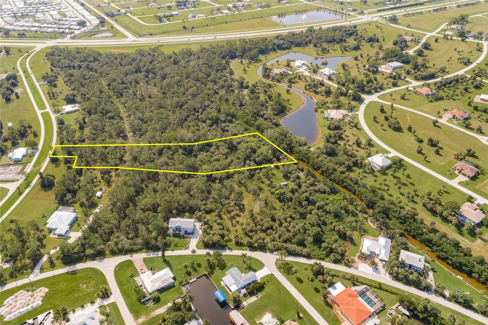 Discover the perfect setting for your waterfront dream home on this 2.11-acre parcel in the desirable waterfront community of Pirate Harbor. Public utilities available.  Boasting approximately 150 feet of saltwater canal frontage, this property offers quick boating access to open water and some of the area’s best fishing right from your backyard. The canal is teeming with game fish and mullet, making it ideal for boating enthusiasts, kayakers, canoe lovers, and flats boats alike. Conveniently positioned just off US-41 (Tamiami Trail) in the desirable Burnt Store Lakes/Pirate Harbor area, the property combines a tranquil, nature-focused setting with excellent access to everyday amenities. To the south, Burnt Store Marina offers waterfront dining, golf, boating, and social activities, along with quick connections to Cape Coral and Fort Myers for expanded shopping, dining, and entertainment. To the north, downtown Punta Gorda, Port Charlotte, and North Port provide additional conveniences, including Harborwalk, Fishermen’s Village, medical facilities, parks, shopping centers, and a wide array of restaurants and services along the US-41 corridor. Residents may also enjoy access to Burnt Store Lakes community amenities such as a park, picnic areas, and a kayak/canoe launch with entry to Charlotte Harbor. Grocery stores, schools, healthcare, and daily essentials are all within a short drive, offering an ideal balance of tranquility and accessibility.   ALSO - An incredible opportunity awaits, as the neighboring lots located at 24413 Jean La Fitte Blvd and 24397 Jean La Fitte Blvd are also available for purchase. Combined, all three connected properties total approximately 6 acres, creating a rare chance to own an expansive waterfront estate with endless possibilities.
