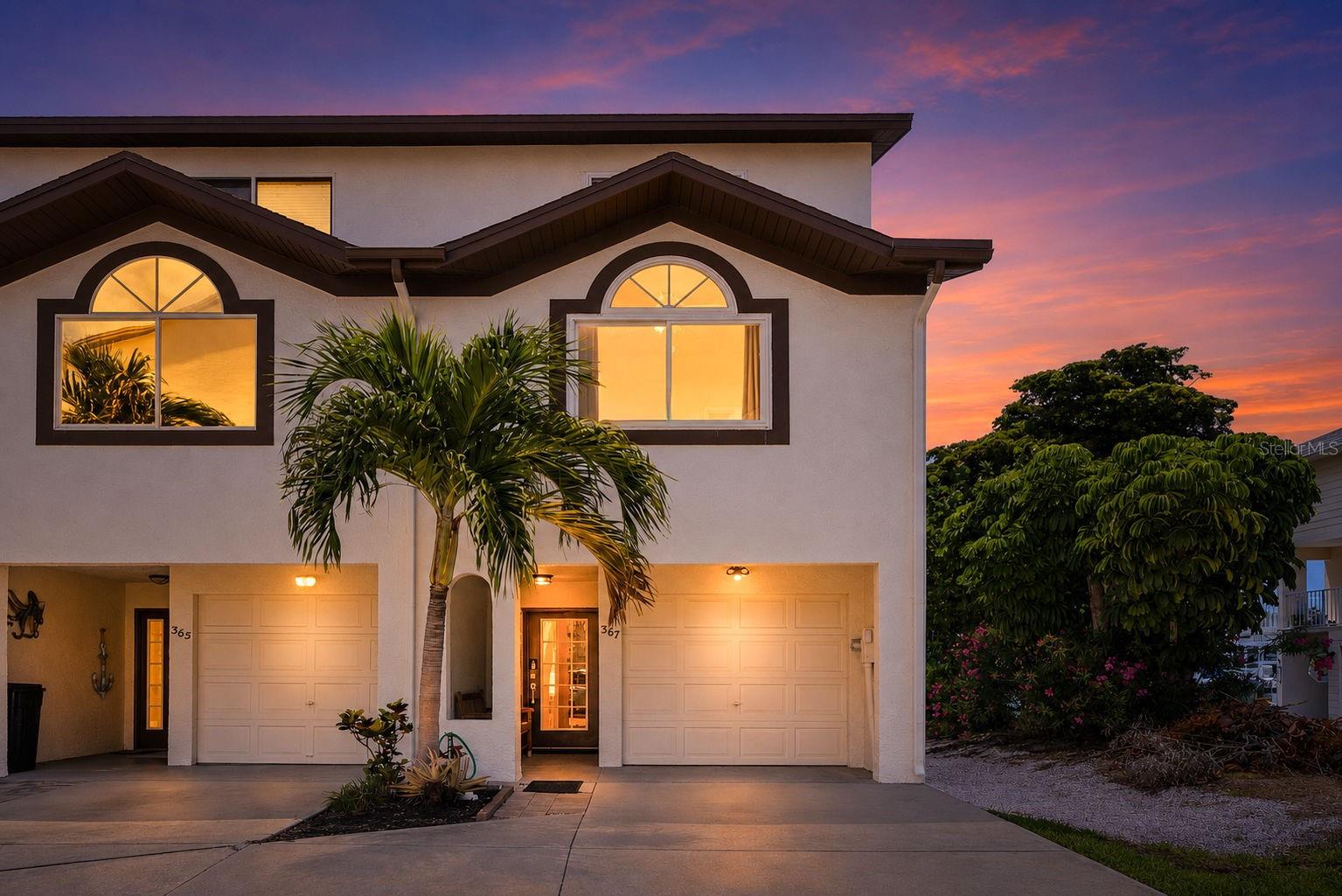 Welcome to waterfront living in the highly sought-after Palms of Tierra community! This beautifully updated 3-bedroom, 3-bathroom end-unit townhome offers the perfect blend of comfort, coastal charm, and boating convenience. Included with the property is a deeded 50-foot boat slip with a 13,000-pound lift, making it easy to enjoy the Gulf waters. Positioned along a protected canal with scenic water views, the home features waterfront balconies that create the perfect setting for morning coffee, evening cocktails, or simply enjoying the Florida lifestyle. Inside, warm 3/4 oak-wood flooring, vaulted ceilings, and abundant natural light create a welcoming and spacious atmosphere throughout. The living area includes a wood-burning fireplace, which opens to a waterfront balcony, while the kitchen features custom Hickory Solid Wood cabinetry, premium quartz countertops, stainless steel appliances, generous counter space, and ample storage. The third-floor owner's suite offers a peaceful retreat with vaulted ceilings, dual closets, a private balcony overlooking the water, and a beautiful walk-in shower with whole-slab Italian marble. Additional bedrooms provide comfortable accommodations for family and guests, and three skylights bring natural light into the upper level. The 2-car tandem garage provides space for vehicle storage and other equipment. Updates include a Tempstar HVAC system installed in 2021, hurricane windows, a central vacuum system, and a water softener system. Residents enjoy access to a community pool, clubhouse, tennis courts, and beautifully maintained grounds, with water, cable, and internet included for added convenience. Whether you're seeking a primary residence, seasonal getaway, or waterfront retreat, this exceptional townhome offers an opportunity to enjoy the best of coastal Florida living.