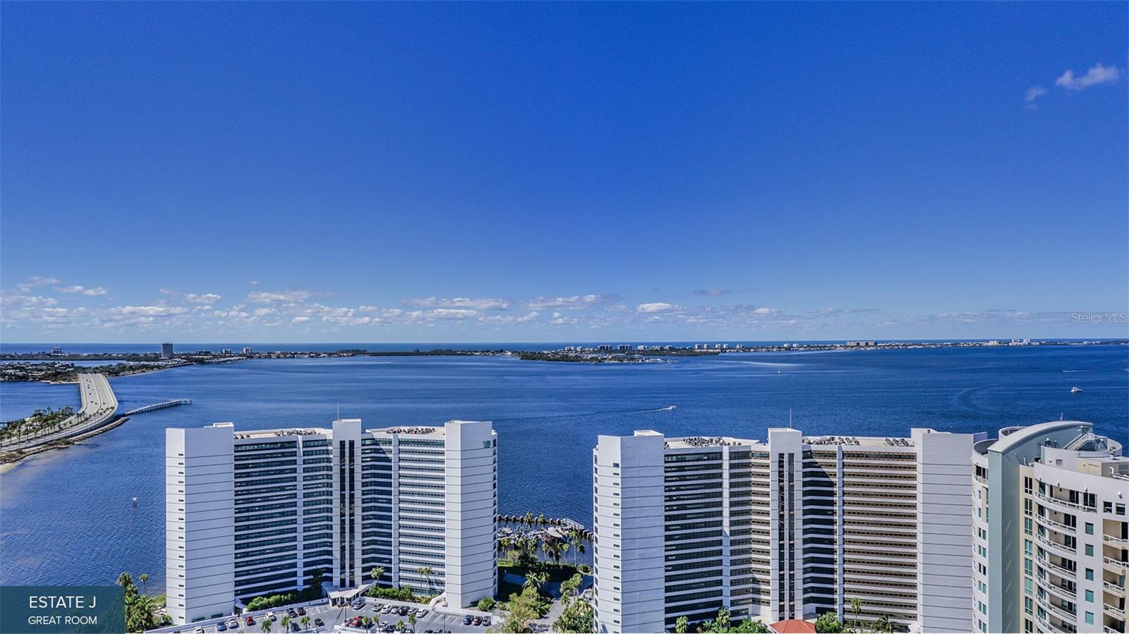 Virtually Staged. Pre-Construction. To be built. Prepare to be wowed. This 20-story Ritz-Carlton Residences tower under construction enjoys a prime waterfront location in the heart of Sarasota's accessible downtown cultural district. Estate 1704 with 13-foot ceilings optimizes beautiful vistas of Quay Harbor, The Bay Park, Sarasota Bay and the Gulf of Mexico. It's an impressive estate. Residence E's design features soaring walls of glass that create an expansive and luxurious great room experience. This spacious area is accentuated by a wraparound terrace with a summer kitchen. The primary bedroom offers a breathtaking bay view through your own private terraced space, complemented by two generous walk-in closets. The spa-style bath boasts a deep soaking bathtub, a double shower and a double vanity. Additionally, two guest bedrooms each come with private en-suite baths and access to separate east-facing terraces. In the Ritz Carlton global tradition of peerless service, this private residence will enjoy a dedicated on-site team that takes pride in anticipating every need and fulfilling every wish. A 24-hour dedicated staff and concierge, food and beverage services available from a private, on-site service kitchen, dedicated 24-hour valet, housekeeping services and an impressive array of private amenities overlooking the sparkling yacht harbor. In addition to the exceptional private amenities and services available exclusively to our tower residents, membership in The Harbor Club provides access to nearly 20,000 square feet of amenities dedicated to socializing, health and wellness.