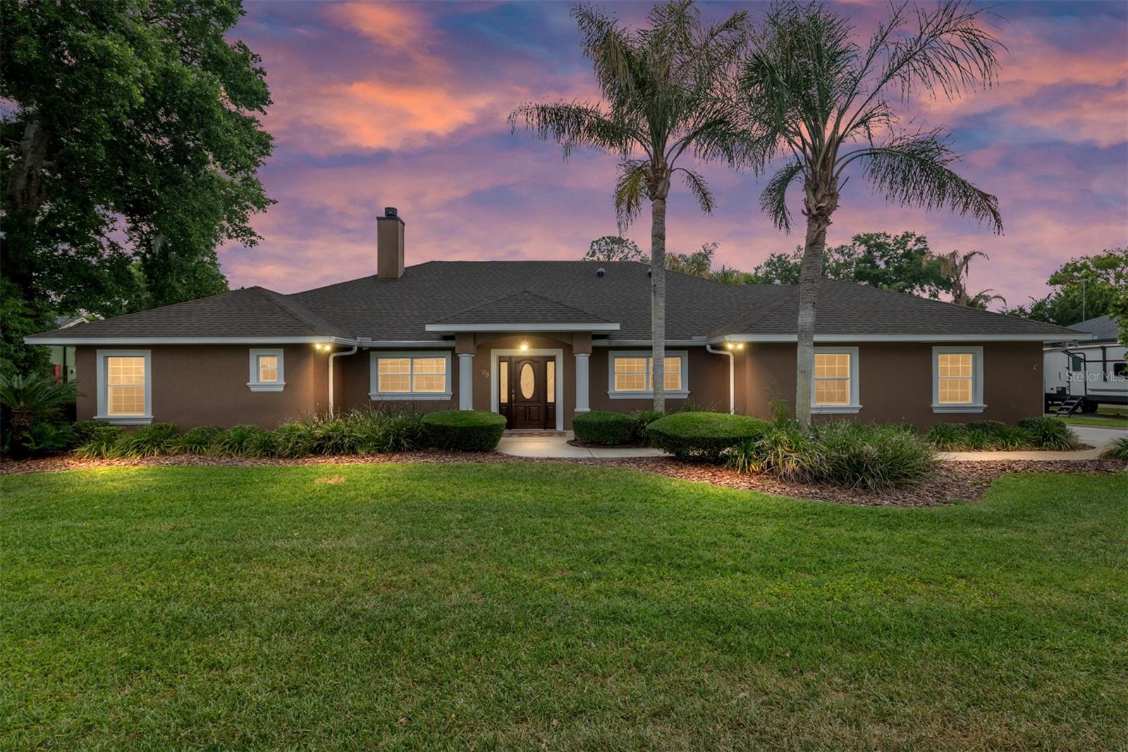 Welcome to your private lake retreat—where comfort, efficiency, and resort-style living
come together. This beautifully designed 4-bedroom, 2-bath home also features a dedicated
office (or optional 4th bedroom), gym, and spacious game room, offering flexibility for both
everyday living and entertaining.
Step inside to a thoughtfully designed open floor plan that creates a seamless flow between
the living room, kitchen, and game room—all with stunning views of the pool and outdoor
living spaces. The kitchen serves as the heart of the home, featuring vaulted ceilings, granite
countertops, custom maple cabinetry, and premium appliances including a KitchenAid
refrigerator, built-in oven and microwave combo, glass cooktop, and Bosch dishwasher.
The living room is warm and inviting with a vaulted ceiling, wood-burning fireplace with gas
log igniter, built-in entertainment center, surround sound, and a 70” Samsung TV—perfect
for relaxing or hosting guests.
Retreat to the luxurious master suite, complete with a cozy window bench with storage, built-
in speakers, a large walk-in closet, and custom cabinetry. The spa-inspired bathroom
features a jetted garden tub, an oversized 6’x6’ dual walk-in shower, and elegant manmade
marble finishes throughout.
Built for efficiency and peace of mind, this home includes insulated concrete form walls with
a 6” concrete core, Icynene attic insulation, solar photovoltaic system, solar hot water 11/09,
energy-efficient Low-E windows, and a 4-ton Trane AC system 9/2015.  Enjoy exceptionally low
electric bills averaging just $150/month. Additional features include smart home wiring, a
monitored alarm system, built-in safe, and a newer roof (2021).
Step outside to your own private oasis. The custom saltwater pool with aggregate finish is
solar heated and enclosed within a screened lanai, complemented by a brick paver deck
and a fully equipped outdoor kitchen with grill, side burner, and sink—ideal for year-round
entertaining.
Enjoy true lake living with two personal watercraft lifts, a covered boathouse with electric
winch, durable seawalls, and a lake-fed irrigation system. The extensively landscaped
grounds provide exceptional privacy, while brick paver walkways and a fire pit create the
perfect setting for relaxing evenings by the water. Additional highlights include a fully equipped game room with granite counters and a
slate/hardwood pool table, a utility room with second refrigerator and custom cabinetry, and
a 2-car garage with workshop space and water softener system.
This one-of-a-kind lake property offers the perfect blend of luxury, functionality, and energy
efficiency—designed for making memories and enjoying the best of waterfront living.