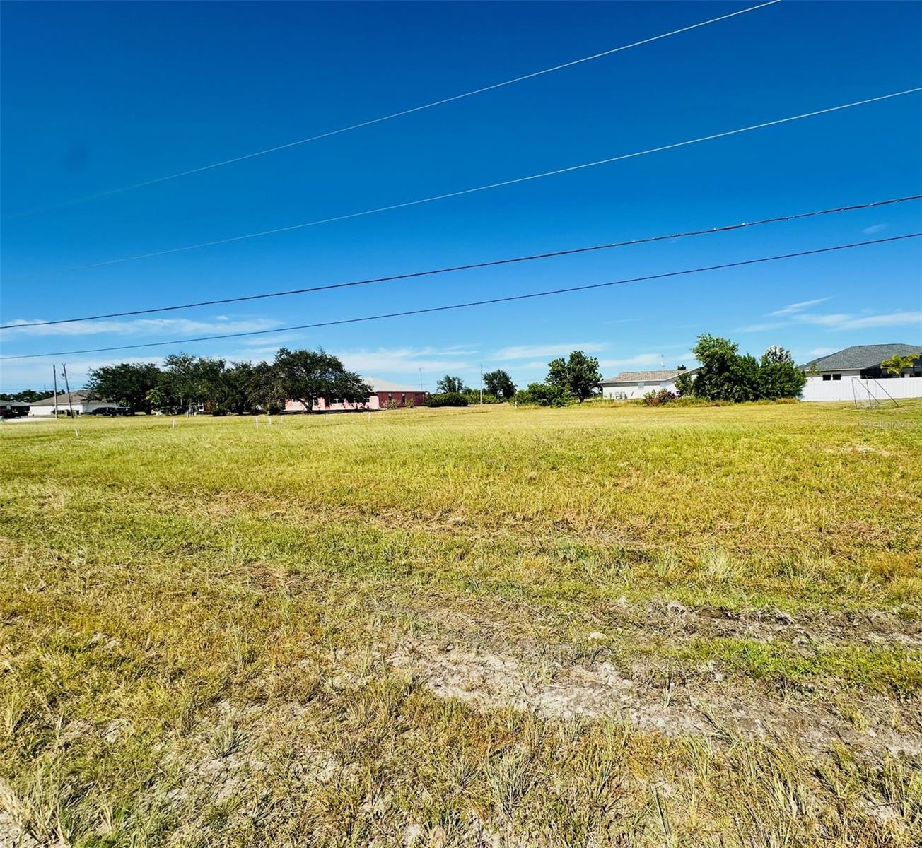 Discover the perfect opportunity to own a .23-acre residential homesite at 2053 NW 3rd Street, Cape Coral, FL, ideally situated in one of Southwest Florida’s most sought-after and rapidly expanding communities. Whether you're planning your forever home, a seasonal retreat, or an investment property, this spacious lot offers plenty of room for a custom home, pool, outdoor entertaining area, and tropical landscaping.

Located in Northwest Cape Coral, this property is surrounded by new construction and ongoing development, making it an excellent opportunity to buy in an area poised for continued growth. Adding to the appeal, the brand-new Hector A. Cafferata Jr. K-8 School is currently under construction directly across the street and is scheduled to open for the 2026-2027 school year, enhancing both convenience and future property value.

Cape Coral is known for its extensive network of canals, world-class boating and fishing, beautiful waterfront parks, and year-round sunshine. Residents enjoy easy access to Pine Island, Matlacha, Fort Myers, Sanibel Island, and the Gulf Coast’s stunning beaches. Nearby you'll find shopping, restaurants, golf courses, medical facilities, entertainment, and everyday conveniences, while still enjoying the peaceful atmosphere of a growing residential neighborhood.

With no shortage of recreational opportunities, Cape Coral offers:

Over 400 miles of navigable waterways
Excellent boating, kayaking, and fishing
Multiple golf courses and nature preserves
Family-friendly parks and sports facilities
Easy access to Southwest Florida International Airport (RSW)
A thriving local economy and strong population growth

This affordable homesite presents an outstanding chance to invest in one of Florida’s most desirable coastal cities. Priced at just $49,900, this property combines location, value, and future potential.

Don't miss your chance to secure your piece of paradise in Cape Coral, Florida—where coastal living, growth, and opportunity come together!