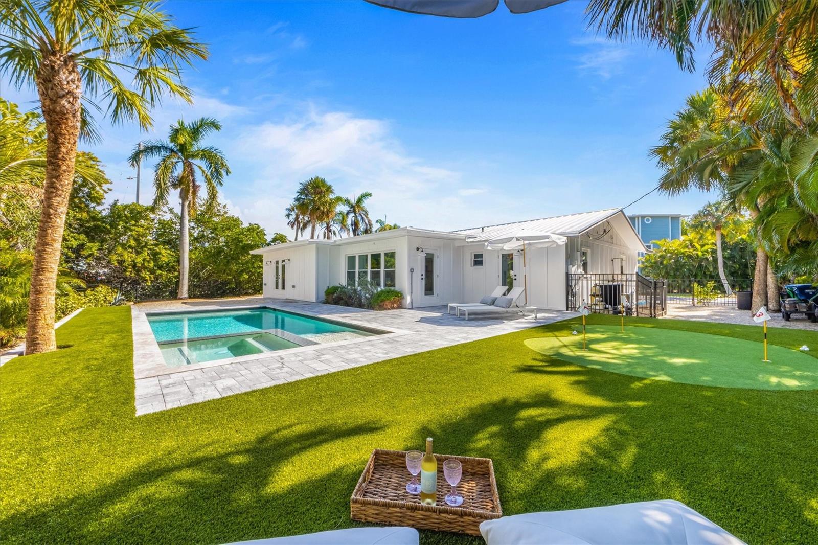 Welcome to your own piece of paradise on Anna Maria Island! This is a BRAND NEW remodel including new metal roof, all new plumbing and electrical, pool/spa and turf and much more! This charming coastal home offers the perfect blend of comfort and island living. Nestled off a quiet street, this property is just a short stroll from the stunning Gulf of Mexico beaches. Featuring 3 bedrooms and 3 bathrooms, its spacious enough for family and guests. One bathroom having access right off the pool for easy access. The open concept living and dining area create an inviting space for relaxation and entertainment. The updated kitchen has modern appliances, quartz countertops and plenty of cabinet and storage space with a large island. Enjoy the Florida sunshine in your private backyard oasis, complete with new turf and a putting green, heated pool/spa and lush landscaping. Your garage provides ample storage space for your beach toys and outdoor gear. Holmes Beach is known for its serene atmosphere and friendly community. This is your chance to own a piece of paradise on Anna Maria Island. Whether you're looking for a permanent residence or a vacation retreat, weekly rentals allowed. Property owners in Holmes Beach can lease a boat slip from the city for $600/year! Schedule your private showing today.