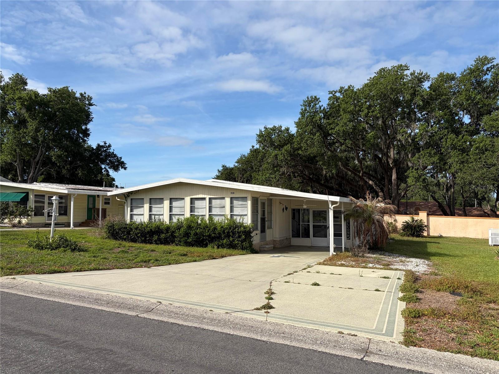 Enjoy the fun and convenience of The Villages lifestyle from this charming home in the historic district. Located in a quiet neighborhood just minutes from shopping, grocery stores, medical facilities, restaurants, and the lively town squares with nightly music and entertainment. Features include a spacious enclosed sunroom, large backyard, wide driveway, new AC, and newer refrigerator and stove/oven. Minimal furnishings make it easy to move right in and make it your own. Whether you're looking for a full-time home or seasonal retreat, this is a wonderful opportunity to enjoy the active, social Florida lifestyle The Villages is known for.