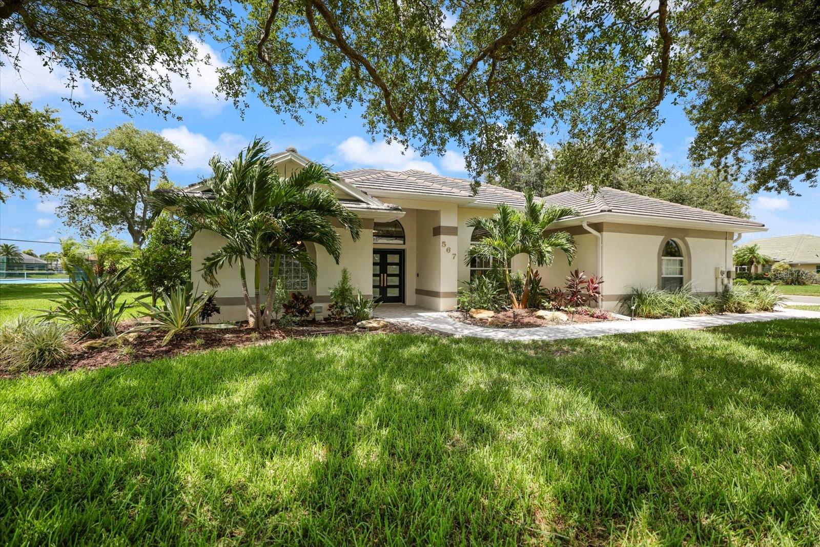 Experience a home where thoughtful updates, quality craftsmanship, and everyday functionality come together. Extensively improved and professionally designed, this residence offers refined living in the desirable Lakes of Jacaranda community.

The remodeled kitchen is both beautiful and functional, featuring soft-close cabinetry, granite countertops, a decorative tile backsplash, WiFi-enabled Chef Connect appliances, a double oven, and a convenient pot filler. High ceilings, crown molding, a custom accent wall, and continuous luxury vinyl plank flooring create a seamless flow throughout the main living areas.

The spacious primary suite offers two custom walk-in closets and a beautifully renovated bath with marble flooring, a soaking tub, an oversized walk-in shower, custom vanities, and designer lighting. Guest bedrooms include custom closet systems, while the updated guest bath features new countertops and a tub/shower combination.

An enclosed, full-width lanai extends the living space year-round with hurricane-rated sliding glass doors, privacy shades, new outdoor carpeting, and views of the professionally landscaped grounds. Plantation shutters, designer lighting, and upgraded fixtures add timeless appeal throughout.

Additional features include a well-appointed laundry room with custom cabinetry and utility sink, plus an attached garage with built-in storage, a utility sink, and a hot water heater booster.

Residents enjoy a community pool, recreational courts, scenic lakes, and mature landscaping, all just minutes from historic downtown Venice, Gulf Coast beaches, shopping, dining, medical facilities, I-75, Wellen Park, and CoolToday Park.

Some photos have been virtually staged to illustrate the home's design potential. Furniture and décor shown may not represent the property's current condition.