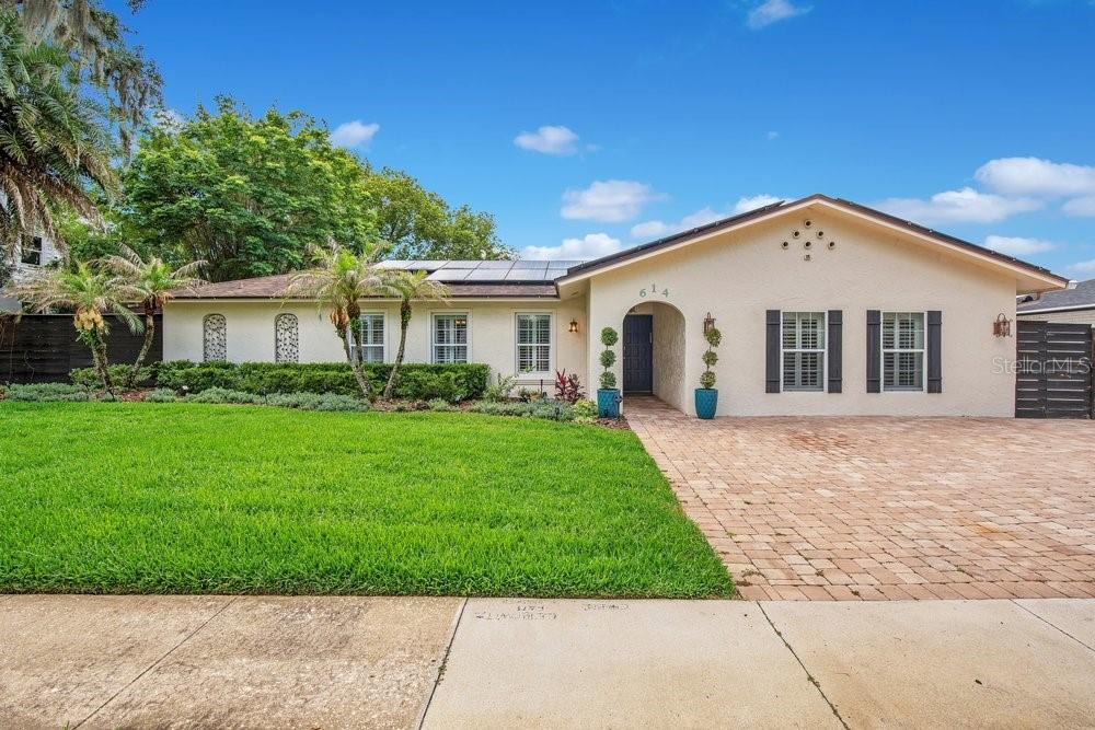 JUST REDUCED - Welcome to this meticulously updated,  one-story masterpiece situated on a sprawling, professionally landscaped 1/3-acre lot. This 5-bedroom, 3.5-bath sanctuary plus bonus room seamlessly blends high-end design with modern efficiency. At the heart of the home lies an extra-large gourmet  kitchen designed for the serious chef, featuring double ovens, dual microwaves, and two dishwashers. The culinary space flows effortlessly into an impressively large dining room, while the living room offers a cozy retreat centered around a classic wood-burning fireplace, perfect for crisp winter mornings. The interior has been refreshed with a brand-new neutral paint palette that complements the fully updated bathrooms and high-end finishes found throughout. Outside, the large fully fenced backyard serves as a private oasis, boasting a stunning pool and ample space for grand-scale entertaining. A massive storage shed, equivalent in size to a full garage bay, conveys with the property to provide incredible storage or workshop potential. This home offers ultimate peace of mind with significant mechanical upgrades, including a 2021 AC unit, 2019 water heater, 2013 roof, and a new pool pump, new interior doors throughout and new door hardware as well   Also Plantation Shutters throughout. Sustainability meets savings with a solar panel system that slashes the electric bill to approximately $50 a month for this expansive home. Whether you are seeking a fabulous primary residence, vacation home or a high-performing investment property, that can also be rented as a short -term rental/Airbnb this is the home for you.  Available furnished or unfurnished.   Garage was converted to a bonus room and laundry with a ½ bath and a small second kitchen. It can easily be converted back to a garage.   Well water used for in ground sprinklers, a huge savings on your water bill.   This rare find delivers the space, privacy, and modern luxury today’s buyers demand. Near everything including Whole Foods, Trader Joes, Great Winter Park- Park Ave Shopping, Dining and galleries.