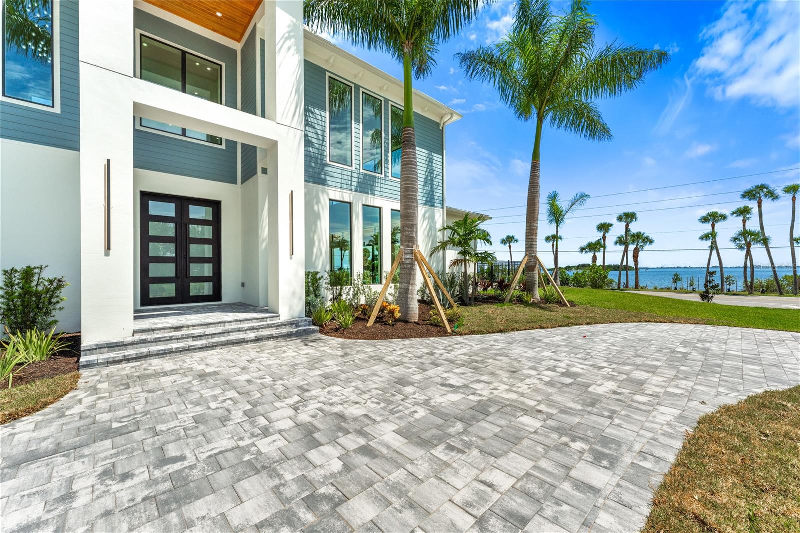 One or more photo(s) has been virtually staged. Introducing the Space Coast's newest Modern Masterpiece- a true showcase property: 4861 Honeyridge Ln at Honeymoon Hill. This 2024 brand-new coastal modern estate is the ultimate statement home on the Space Coast. Poised against the canvas of nature's most desirable backdrop: the open water. Upon entering the 10 ft iron doors, looking up you will notice cypress tongue & groove wood detailing throughout the living area and your own private wine room off the impressive entry foyer. With over 30+' ceilings at its highest point, the open central living space is truly grand & expansive, reflecting a one-of-a-kind atmosphere you deserve. Superior construction materials and designer finishes equate to the ultimate living experience. High-end Jenn Air appliances, full quartz countertops & matchbook backsplash, and hidden walk-in pantry w/ luxury series selections in kitchen.

Downstairs, the owner's retreat features a show stopping walk-in closet w/ custom built-in design, gorgeous views of the pool and open water, porcelain shower walls, freestanding soaking stone bathtub, & oversized LED backlit anti-fog tempered glass mirror. Latest tech devices charge effortlessly with multiple USB type outlets throughout. Divinely designed heated saltwater pool and spa features smart mobile device control, Colorlogic LED pool and spa lights, and travertine deck & patio with summer kitchen & outdoor fireplace that present a pristine outdoor setting, inviting relaxation and entertainment. A true rarity - this home is one that will be notably recognized as a prized possession for decades to come.