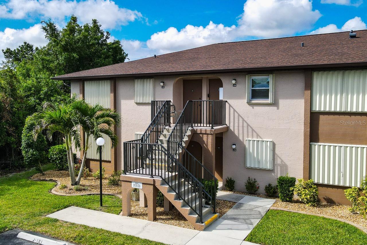 Beautifully Maintained Furnished End-Unit with Lake Views.  Welcome to this 2-bedroom, 2-bathroom end-unit condo in the highly sought-after Deep Creek Gardens community. Enjoy enhanced privacy with no neighboring unit on the left and serene lake views from your private screened lanai.  Inside, the thoughtfully designed kitchen flows seamlessly into the spacious great room, creating the perfect setting for entertaining family and friends. The kitchen features recessed lighting, modern cabinetry, generous counter space, a breakfast bar, and a full appliance package.  The spacious primary suite offers a walk-in closet and a private en-suite bath with a tub/shower combination. The guest bedroom also includes a walk-in-closet and convenient access to the guest bathroom, complete with a walk-in shower. An interior laundry closet with a stacked washer and dryer adds everyday convenience.  Step outside to the tiled, screened lanai and unwind while taking in tranquil lake views and stunning Florida sunsets. Ample parking is available for residents and guests, and each unit is equipped with hurricane shutters for added peace of mind.  The community offers an impressive array of resort-style amenities, including a heated pool and clubhouse, tennis and pickleball courts, bocce and shuffleboard courts, and a community covered cookout area with tables, chairs and grills. An additional grilling area with tables/umbrellas is conveniently located just steps from the condo (near Building I).  Per seller, the roof was replaced in 2023, the A/C unit in 2024, and the water heater in 2018.  Ideally located near shopping, dining, golf courses, parks, and I-75, this move-in-ready home offers the perfect blend of comfort, convenience, and Florida lifestyle. With affordable monthly fees covering most exterior maintenance, as well as water and sewer, you'll enjoy truly low-maintenance living.