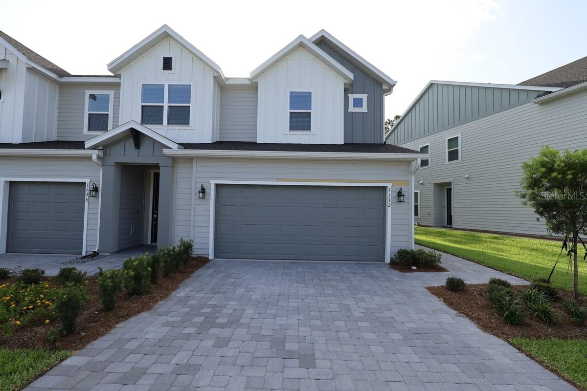 Under Construction. This beautifully designed Creekbend floor plan is a brand new creation by the award-winning David Weekley Homes. It’s a corner unit with a private side entrance. This home boasts over 1600 ft² of living space, including a two-car garage, three bedrooms, two full bathrooms and a powder bath. Thoughtfully selected interior features include durable tile flooring throughout common areas and soft carpeted flooring in bedrooms. For added peace of mind each home also comes with a security system. The kitchen cabinetry is full overlay shaker style with designer appointed hardware. Countertops are quartz. The exterior of the home has beautiful paver driveways with a paver lead walk to the front door. The Creekbend is designed to be very energy efficient.