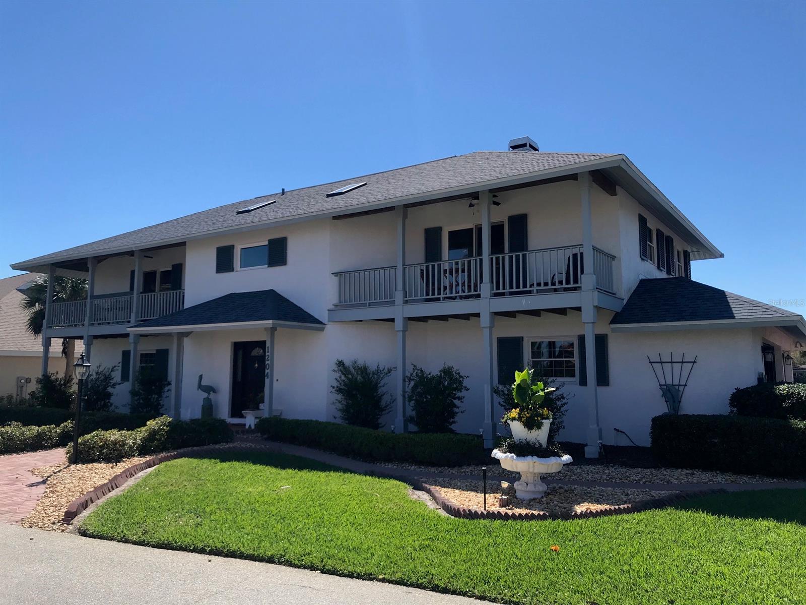 Intracoastal living without large wake erosion or heavy traffic. This lovely home boasts views of water from every room, all bedrooms have either patio or porch to catch the breezes/views, cathedral ceiling in the great room, updated kitchen w/center island & silestone counters, double sided fireplace, elevator, hurricane windows and/or shutters, 3 car garage w/built-in cabinets, updated upstairs bathroom w/glass block handicap accessible shower & Jacuzzi tub, hardwood flooring & bead board w/lots of natural stained wood for a warm & welcoming atmosphere. Full seawall, deep water boat dock w/ 2 power lifts and floating gang plank for the boating enthusiast. Relaxing flower & herb garden surrounding the brick patio for added charm.  A new roof was installed in 2017 too.  The Bahamian style floor plan has the daily living area upstairs (accessible to all by stairs or elevator) to maximize the views from all angles--you have water views from both sides of the house.  There is a master bedroom upstairs or optional master suite down--the choice is yours.  This home is truly an entertainer's delight--your company will never want to leave! ;Water: City